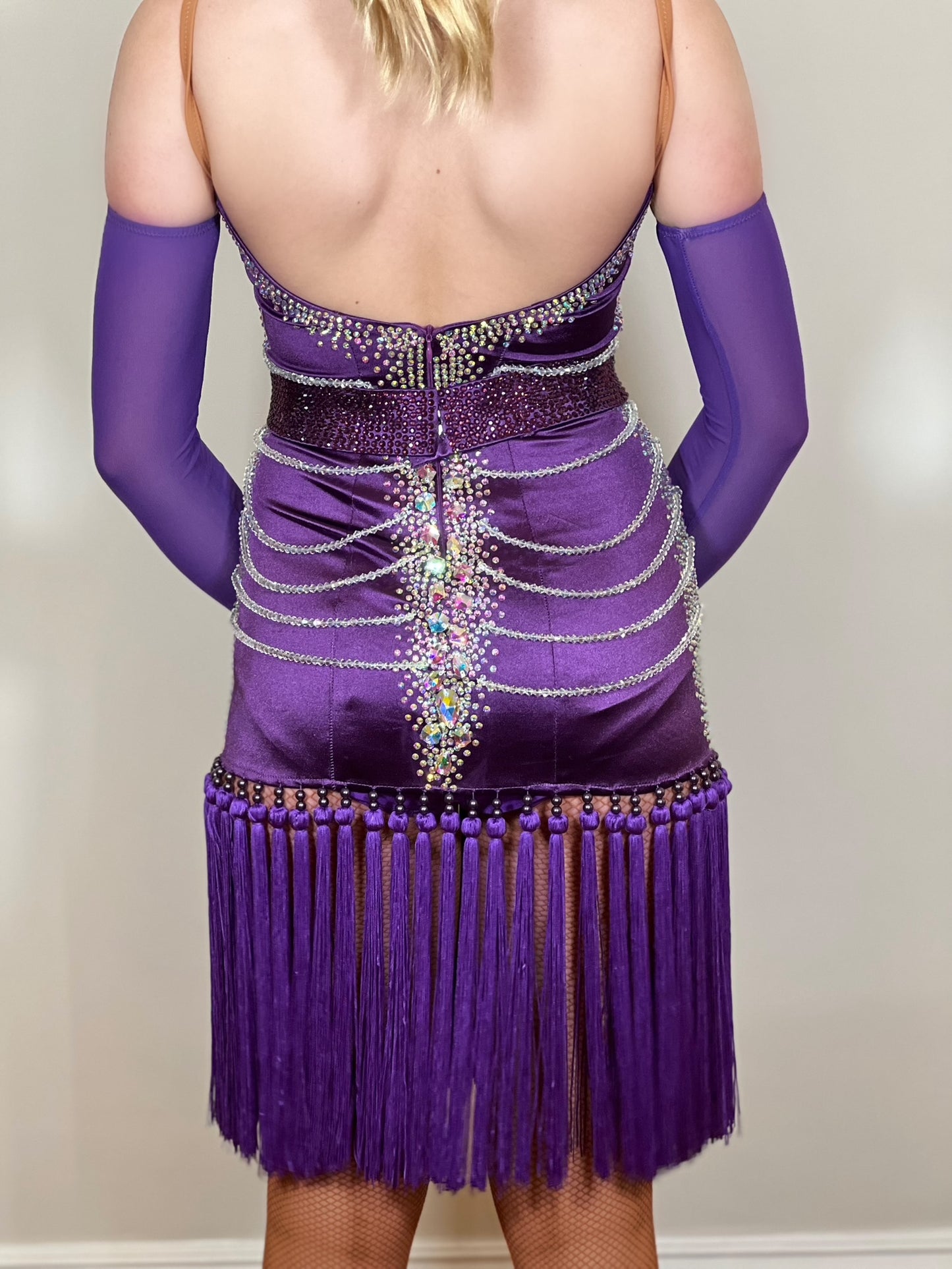 101 Purple Velvet Fringe Skirt Latin Dress. Beaded decorations to front & back of bodice. Stoned in AB with detachable belt. Clumped fringe skirt. Long purple mesh gloves.