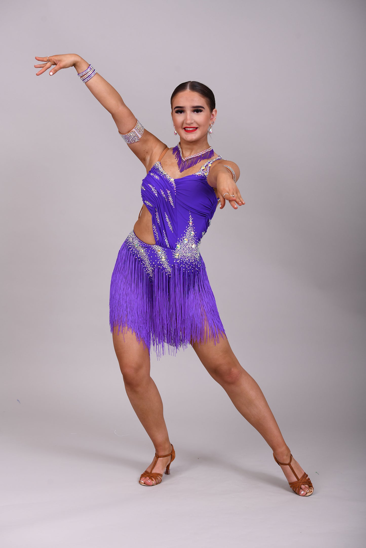 173 Cadbury Purple Latin dance dress. Rouched detailing to the upper body, full fringed skirt. Stoned in AB