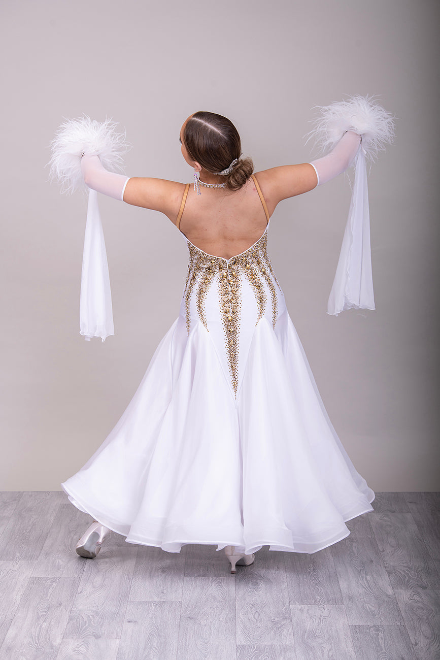 012 Stand out White & Gold Competition Ballroom Dance Dress. 3D design to the Bodice heavily stoned in Gold Ore & Golden Shadow. Detachable Floats with Ostrich feather cuffs.
