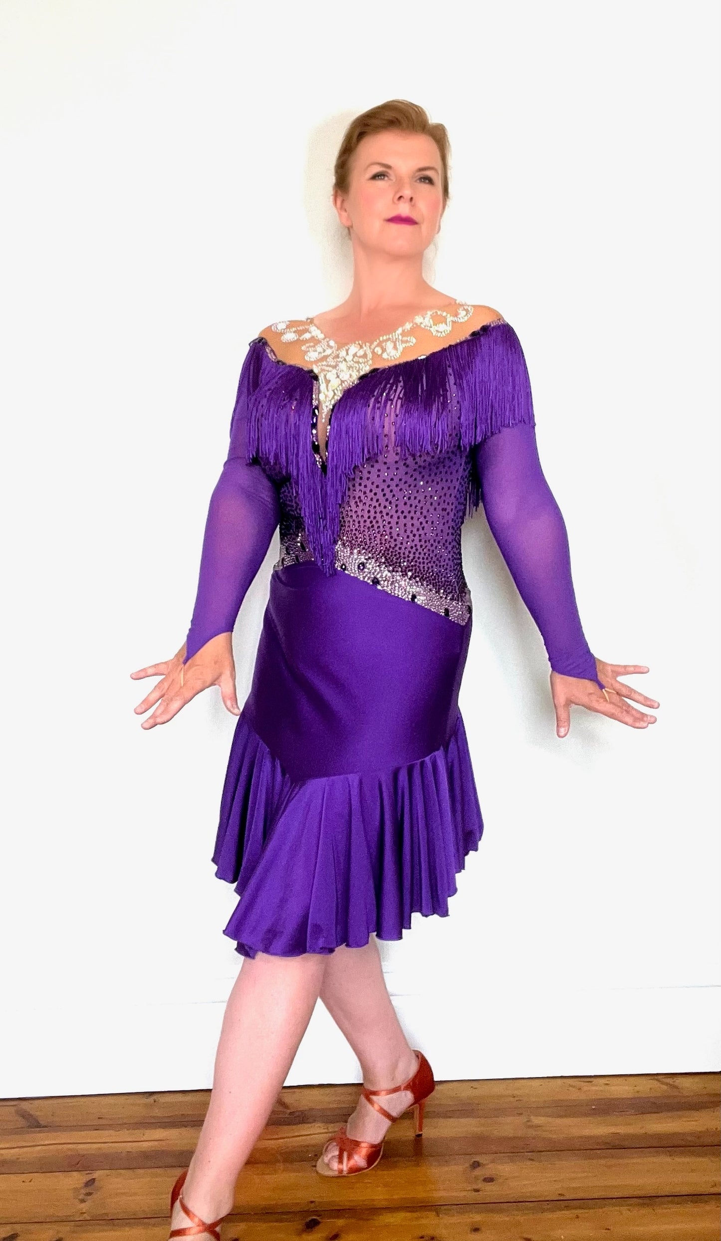 216 Purple Latin Dress with intricate design detailing to the chest & neckline. Heavily fringed at the front & back. AB heavily stoned neckline. Stoned in purple, light rose, magenta & AB