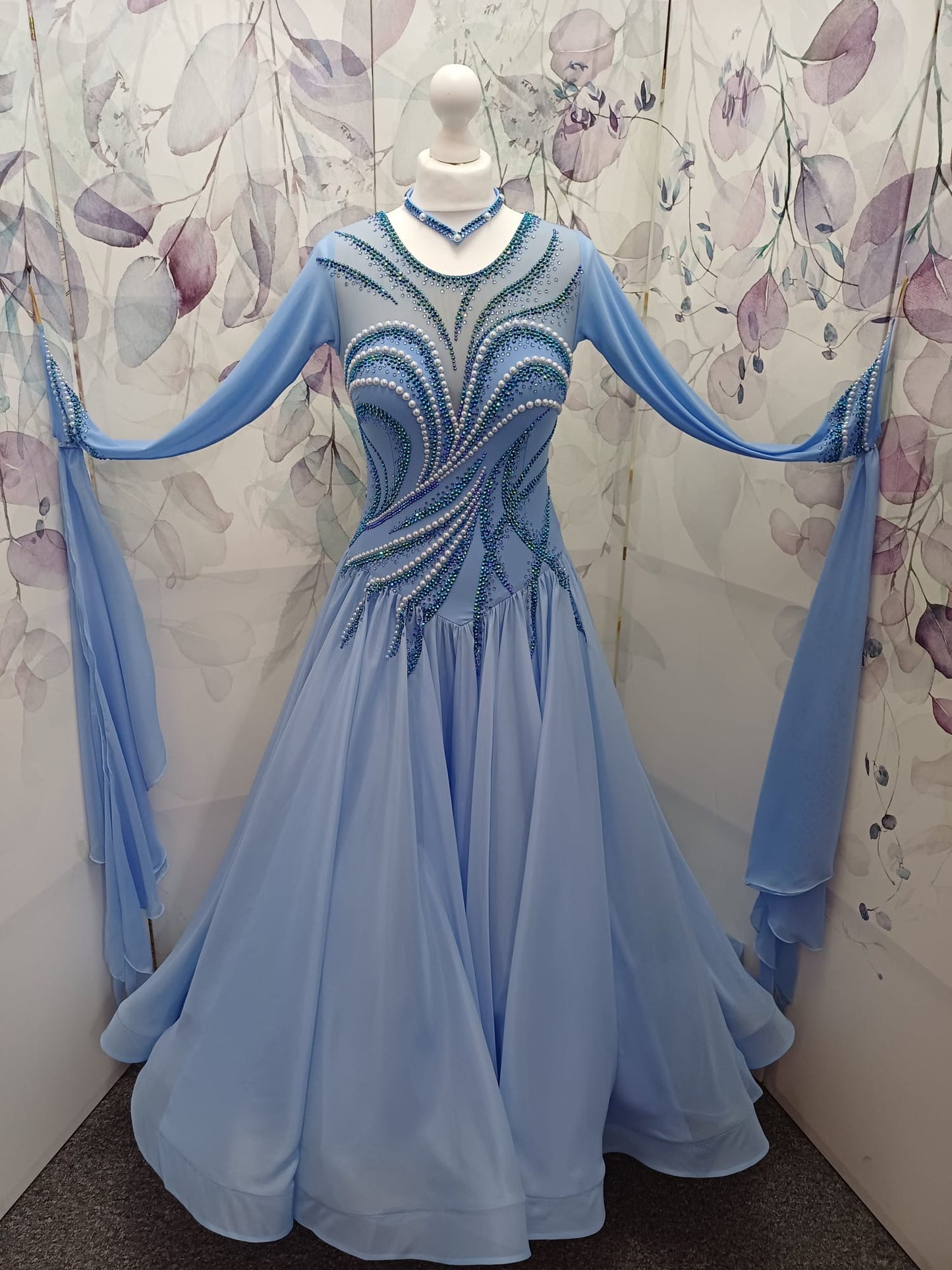 60B TWD ELITE Sky Blue Competition Ballroom/Sequence Dance Dress. New Fuller skirts & Underskirts. Beautiful patterning in Light Sapphire, AB & Light Sapphire AB with White Pearls. Narrow keyhole back. Detachable floats.❤️Showroom Appointments Available❤️