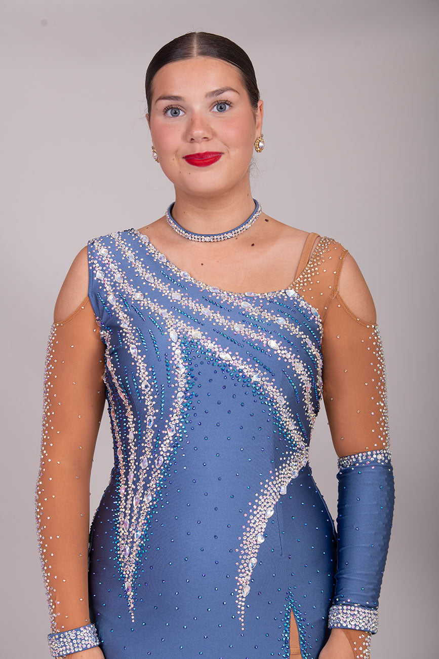 125L Heather Latin Competition Dance Dress. High Back allowing option to wear own Bra. Heather Colour Dress with Cold shoulder sleeves with heavy stoning details. Side splits for maximum leg movement.          Showroom Appointment Available