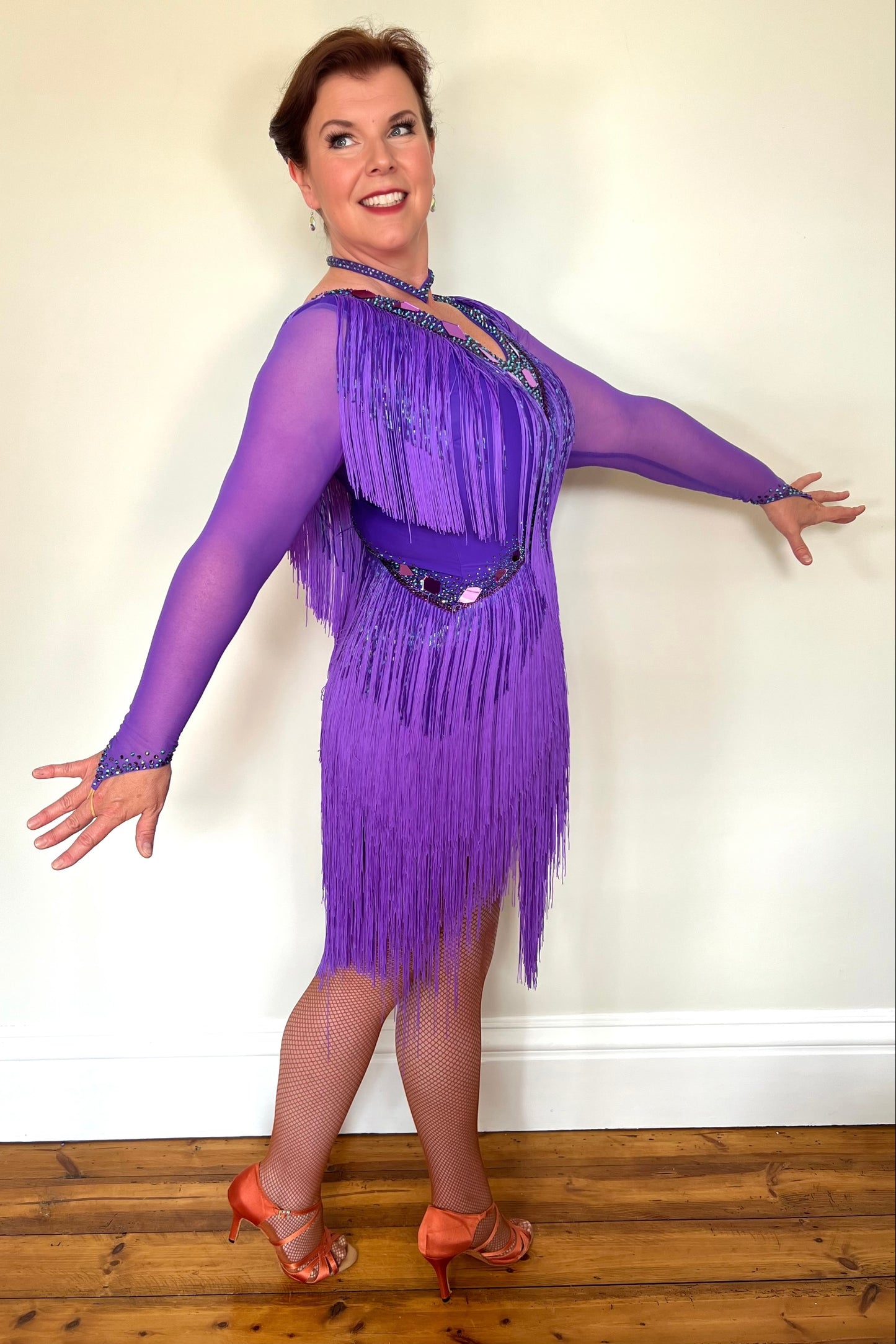 181 Purple Latin Dance Dress. Very full layered fringe. Decorated with purple mirrors, purple bead droppers and purple ab stones. High back to give option for wearing own bra.