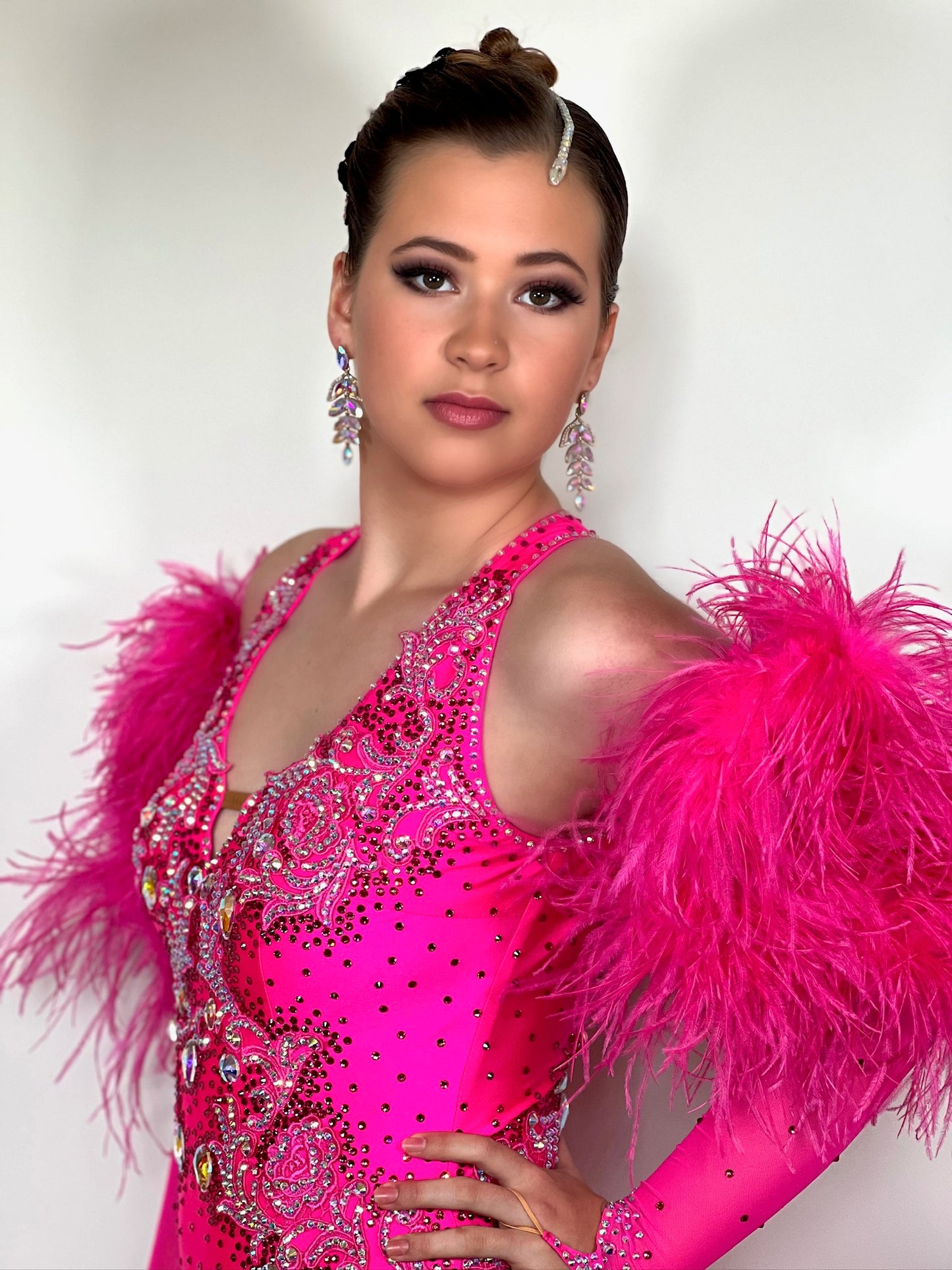 139 Stunning Bright Pink Ballroom dress. Comes with long pink mesh fingerloop gloves and Fluffy ostrich feather cuffs. Decorative back. Stoned in AB, Rose & Light Rose