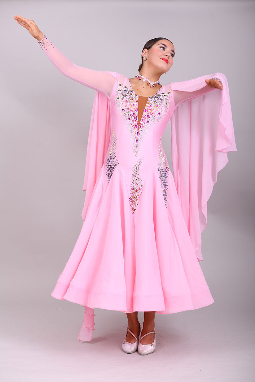 131 Pink Ballroom Dress with shoulder floats. Tan panel to the chest area giving a plunging neckline effect. Decorated in AB & Fuchsia stones