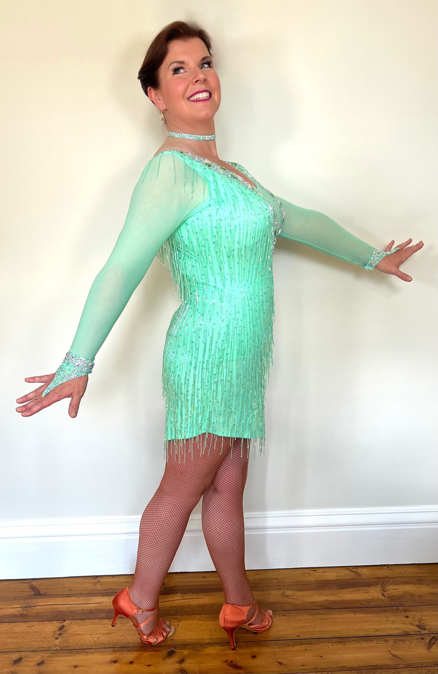 1303 Mint Green Latin Dance Dress. Front mesh panel detail with flesh Lycra under so not see through. Stoned in AB and mint ab stones. Mint Green bead droppers. High back giving option to wear own bra.