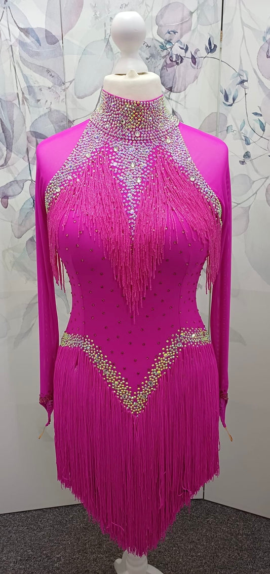 52L Striking Pink Competition Latin Dance Dress. Full fringed skirts with heavy stoning detail in AB & Rose. Flattering bodice shaping. ❤️Showroom Appointments Available❤️