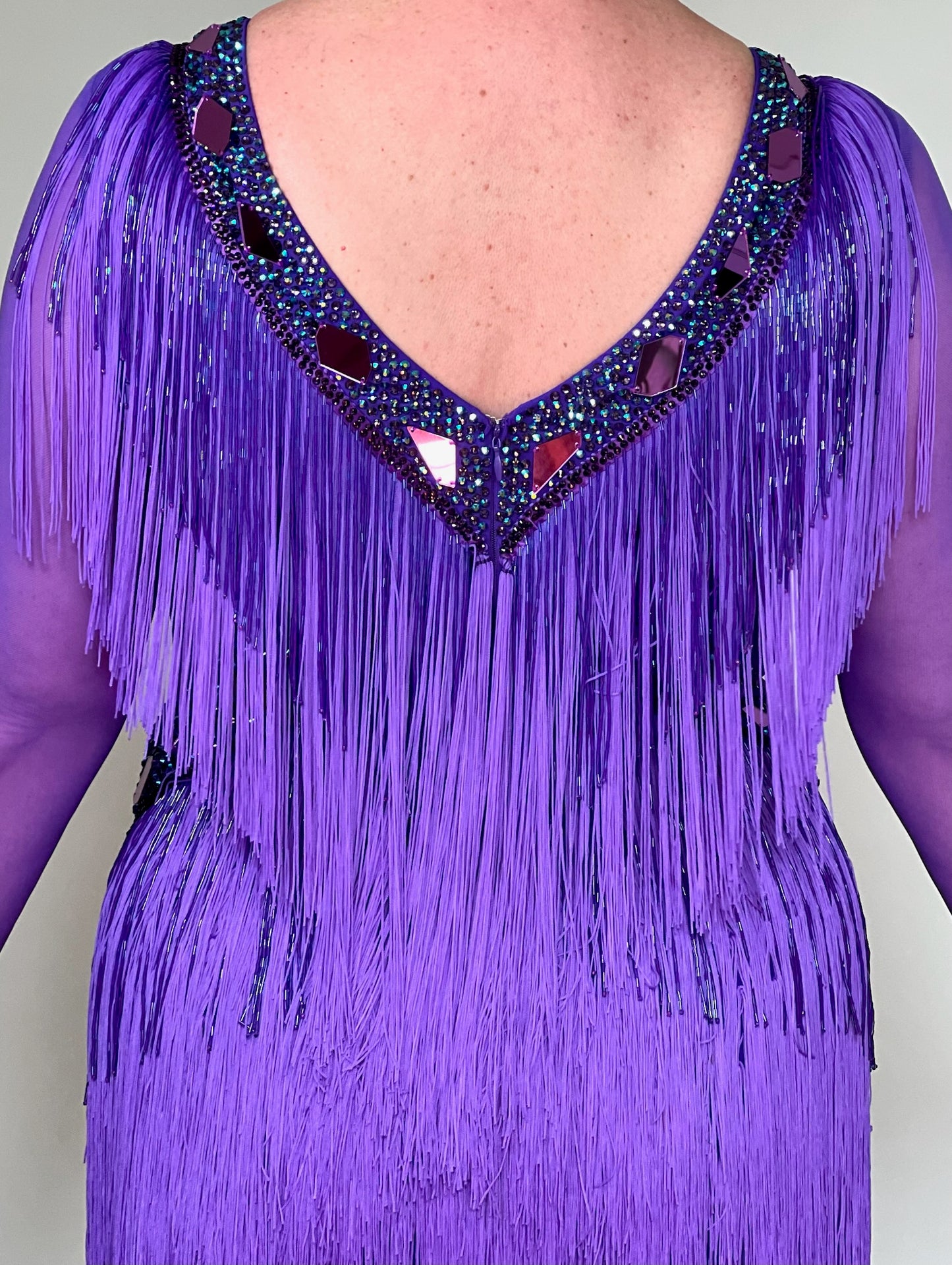 181 Purple Latin Dance Dress. Very full layered fringe. Decorated with purple mirrors, purple bead droppers and purple ab stones. High back to give option for wearing own bra.