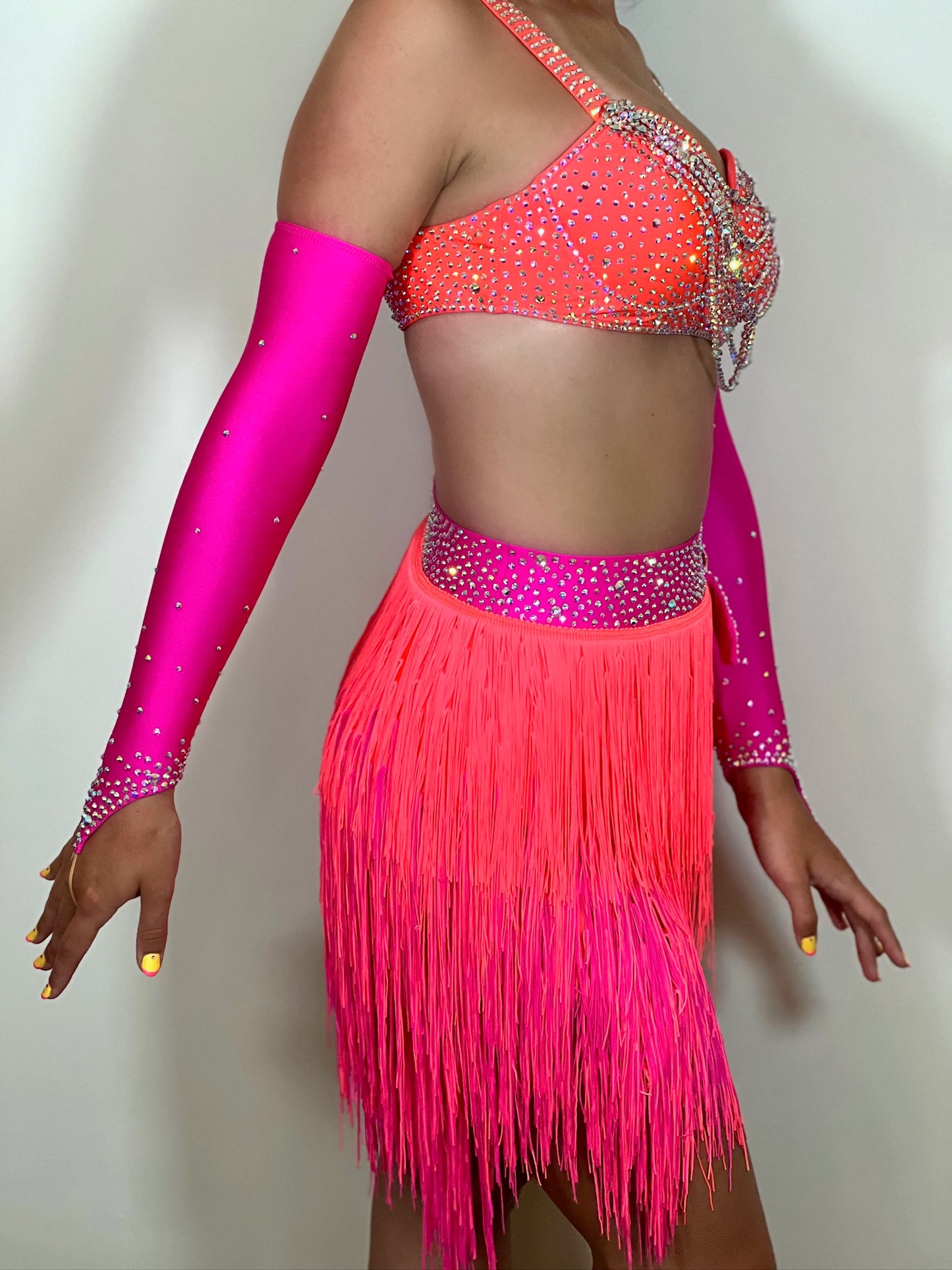 153 Flo Pink & Flo Orange Latin Dance Dress 2 Piece. Cones with separate gloves. Heavily stoned in AB with belt detail to the skirt