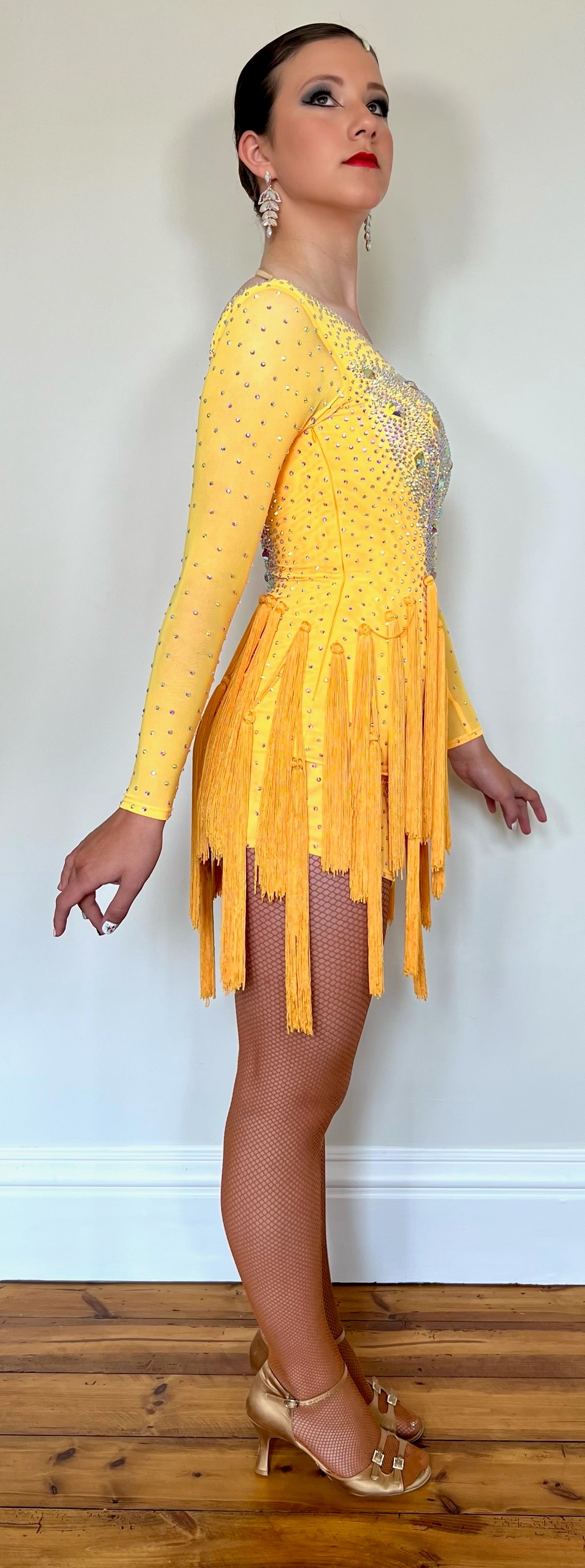 021 Golden Yellow tasseled skirt Latin dress. Decorated in AB with stoned sleeves.