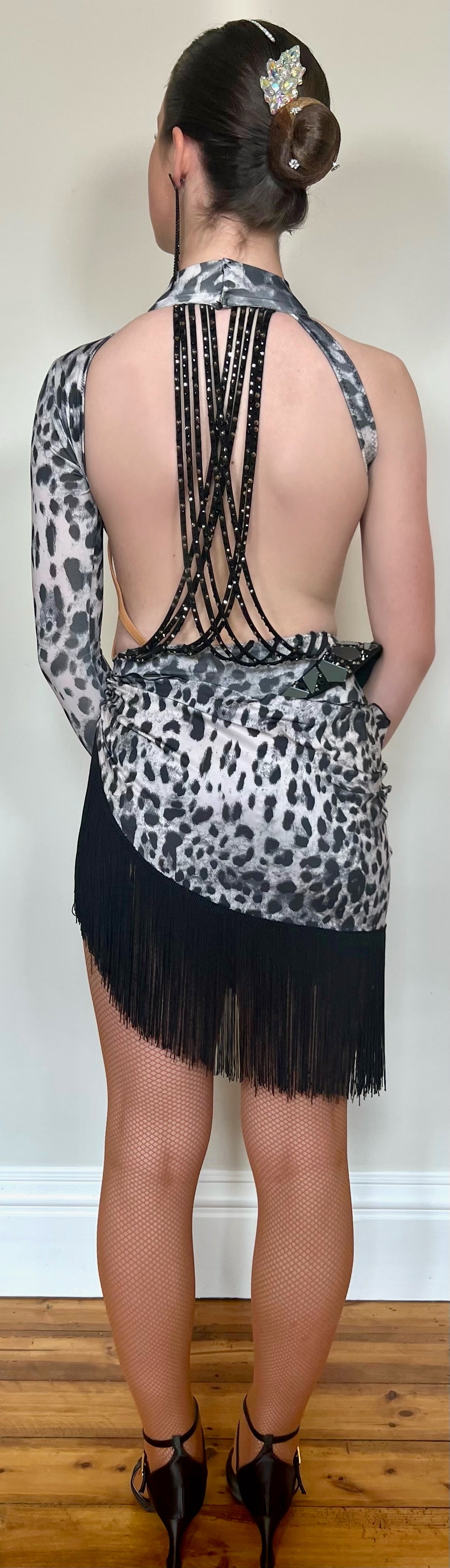 093 Black & White Leopard Cut Out one sleeve Latin Dress. Hanging detail to back decorated with black mirrors & jet stones. Rigid detail to right hip.