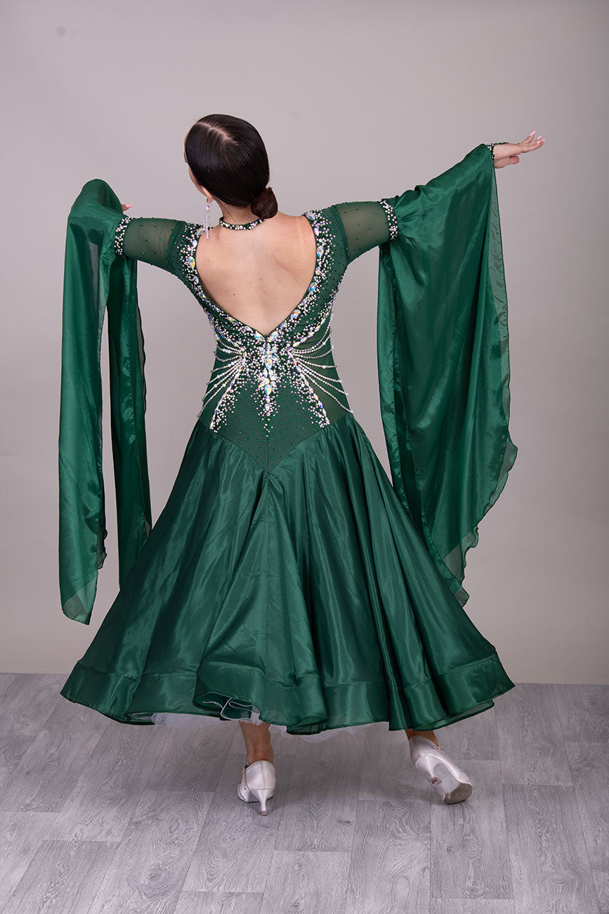 50B TWD “PETITE” Jade Green Competition Ballroom Dance Dress. Beautiful hanging strap detail on the hips. Heavily stoned in AB & Emerald & pearls. Bell sleeves. ❤️Showroom Appointments Available❤️