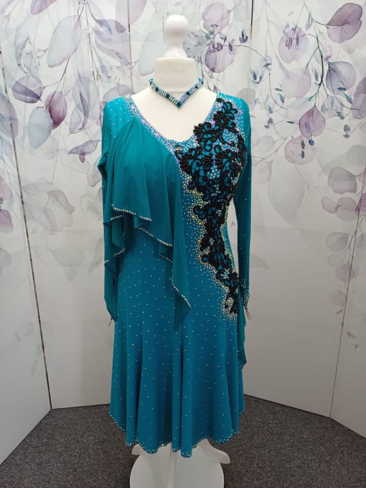 60L Teal Competition Latin Dance Dress. Beautiful Teal colour. Black pearls & AB stones with overlay detail to the chest & Back hip giving flattering lines. ❤️Showroom Appointments Available❤️