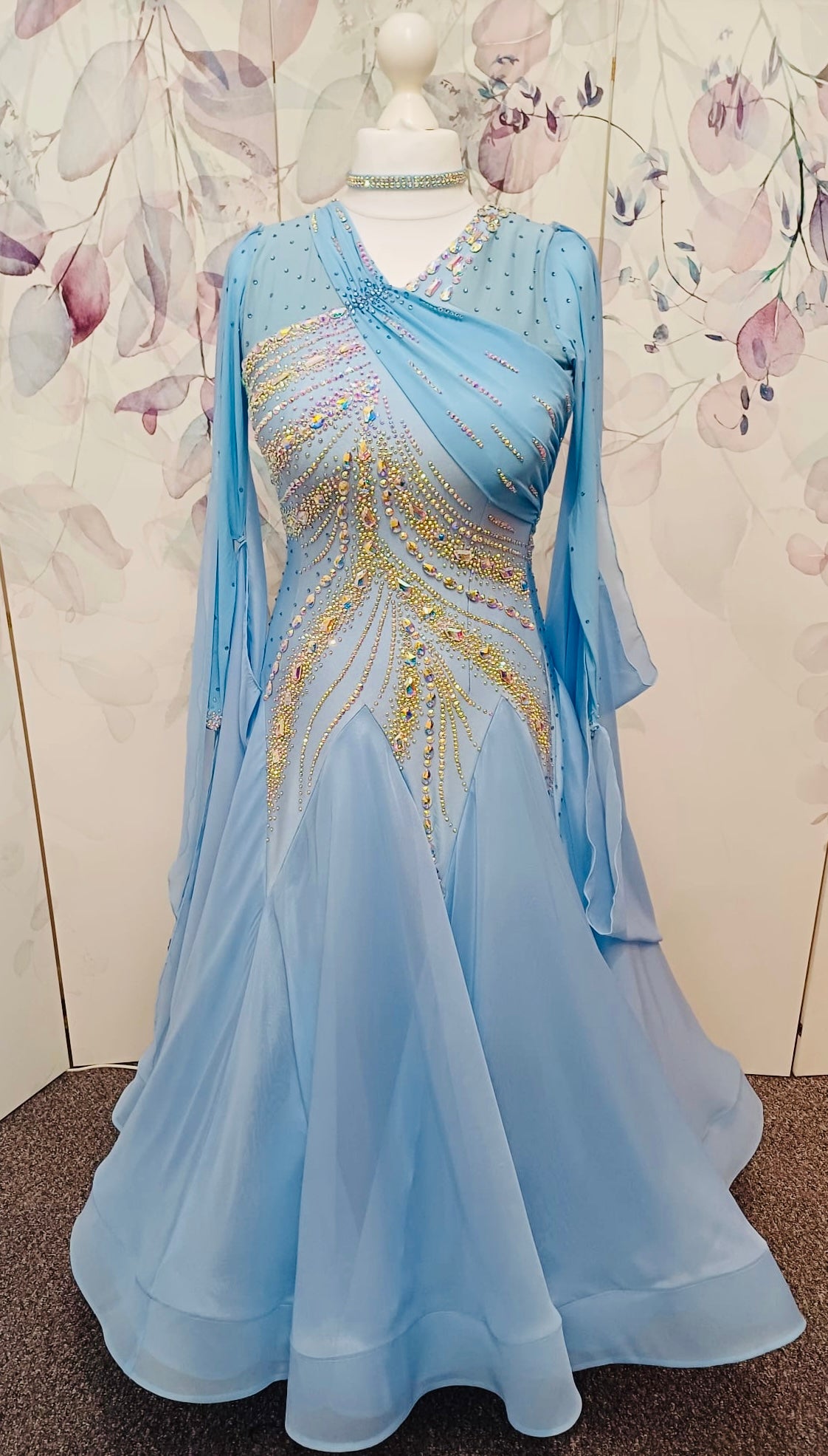 007 Light Blue Competition Ballroom Dance Dress. Heavily stoned in AB & Blue. Mesh overlay to one side of the bust continuing round to the back. Comes with detachable floats.