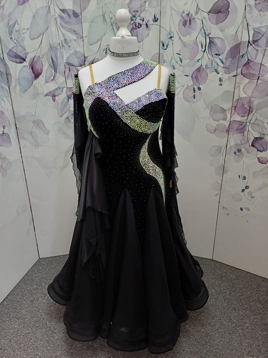64B Classic Black Competition Ballroom dance dress. Flattering design heavily stoned in AB & Jet. Detachable floats. Satin frill to the front right bodice. Back high enough to wear own bra.