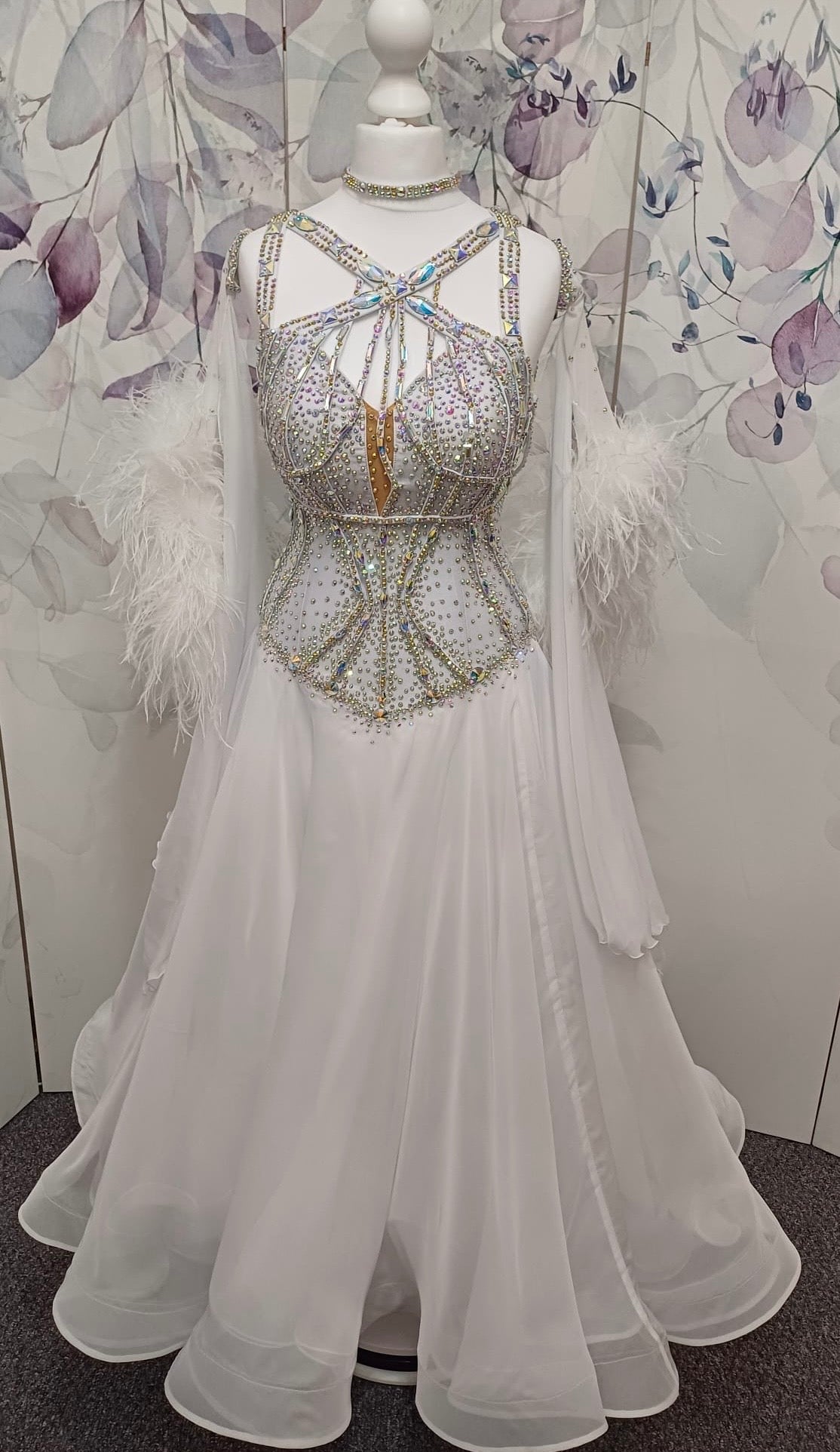 013 White Competition Ballroom/Sequence Dance Dress. Striking detailing to both the front & Back. Stoned in AB and sunshine. Cones with gloves, floats & Ostrich Boa cuffs.