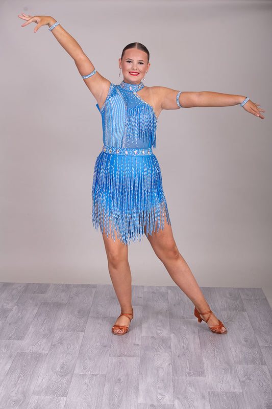 134L BUDGET (24) Blue Competition Latin Dance Dress. Stoned fabric strip detail throughout with 3D feature yo upper chest. Stoned in AB ❤️Showroom Appointments Available❤️