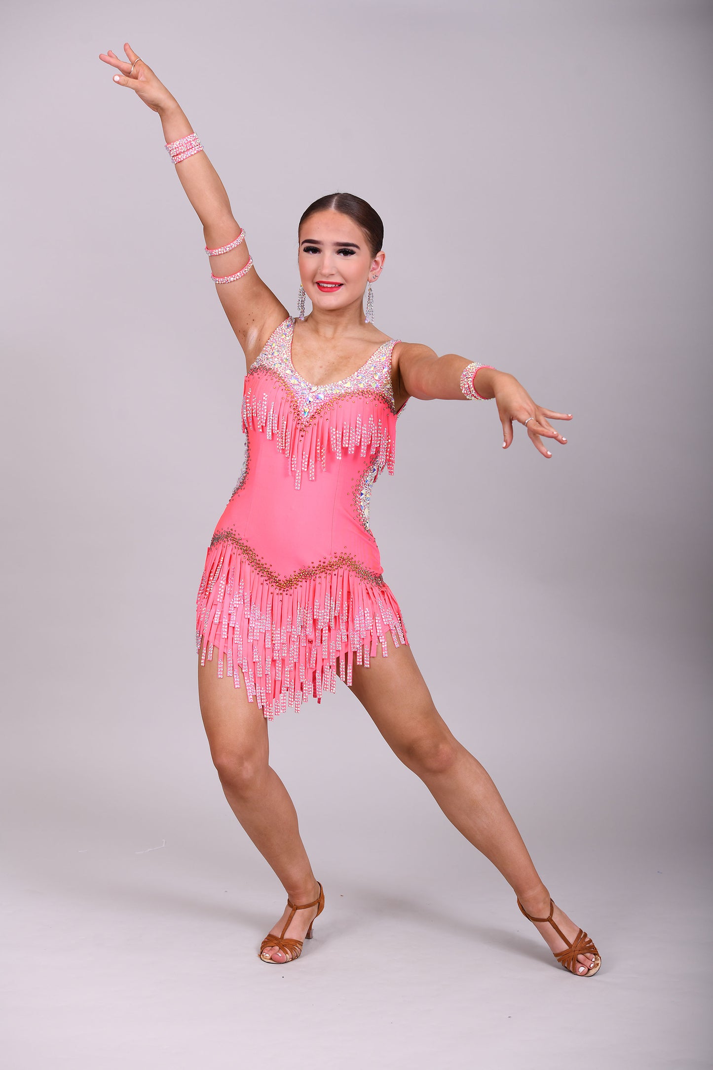 003 Coral Competition Latin Dance Dress. Full stoned fabric fringe details to chest and skirt. Includes bracelets. Stoned in AB & Hyacinth AB