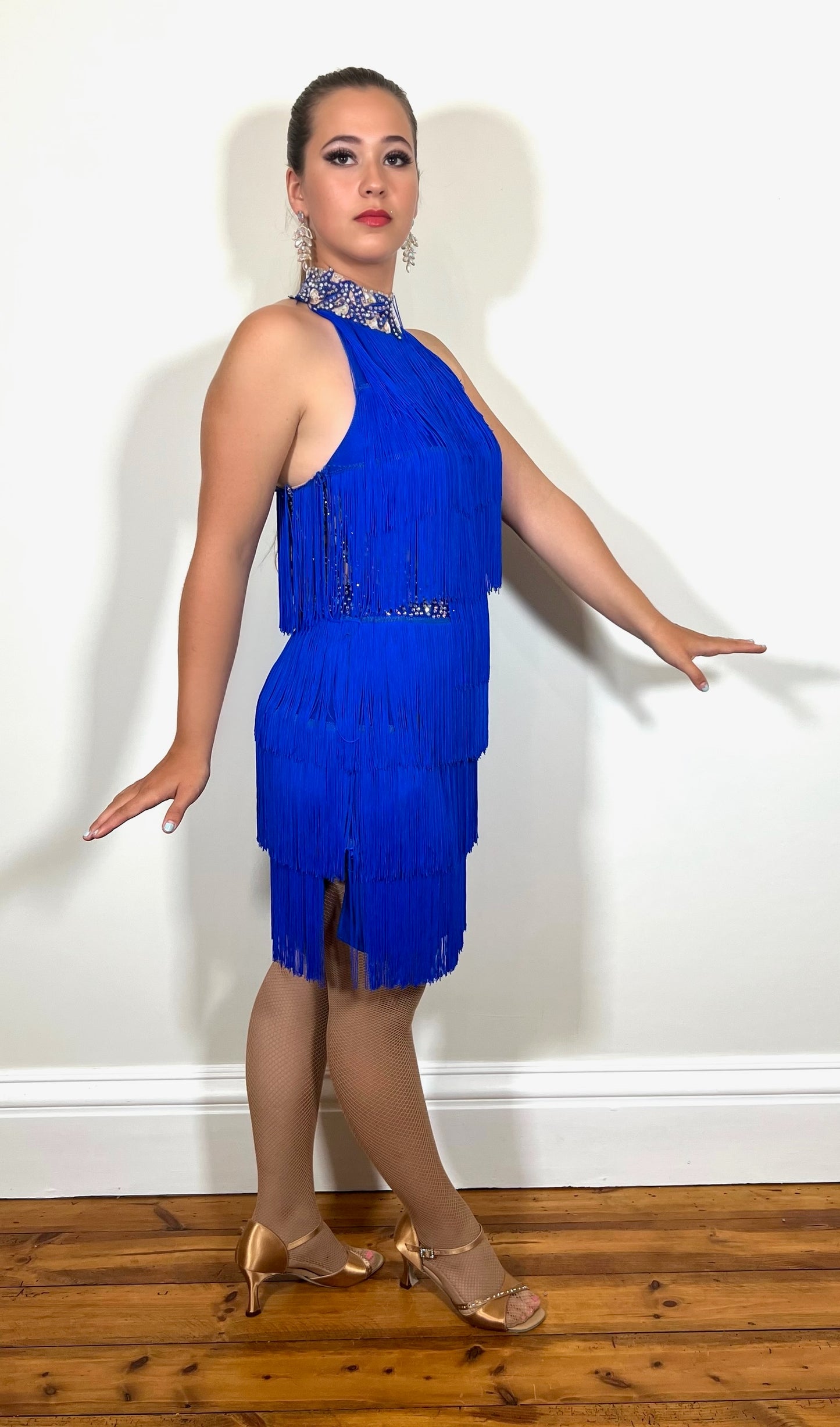 221 Bright Royal Blue Fringed Leotard and separate fringe skirt. Appliqué detailing to the waistband & Collar with flesh Lycra panels to the sides also decorated in appliqué. All stones are AB & Sapphire.