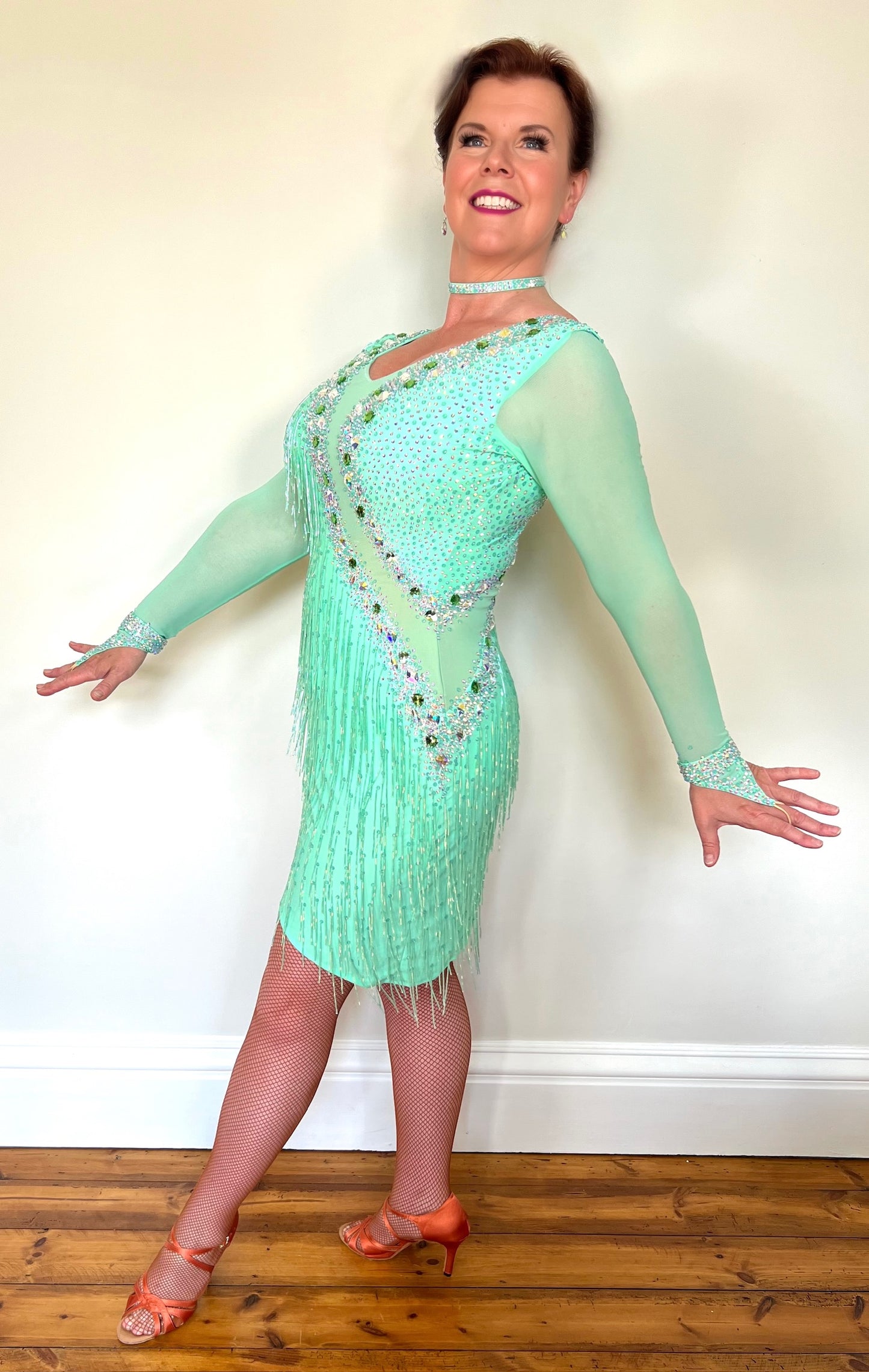 1303 Mint Green Latin Dance Dress. Front mesh panel detail with flesh Lycra under so not see through. Stoned in AB and mint ab stones. Mint Green bead droppers. High back giving option to wear own bra.