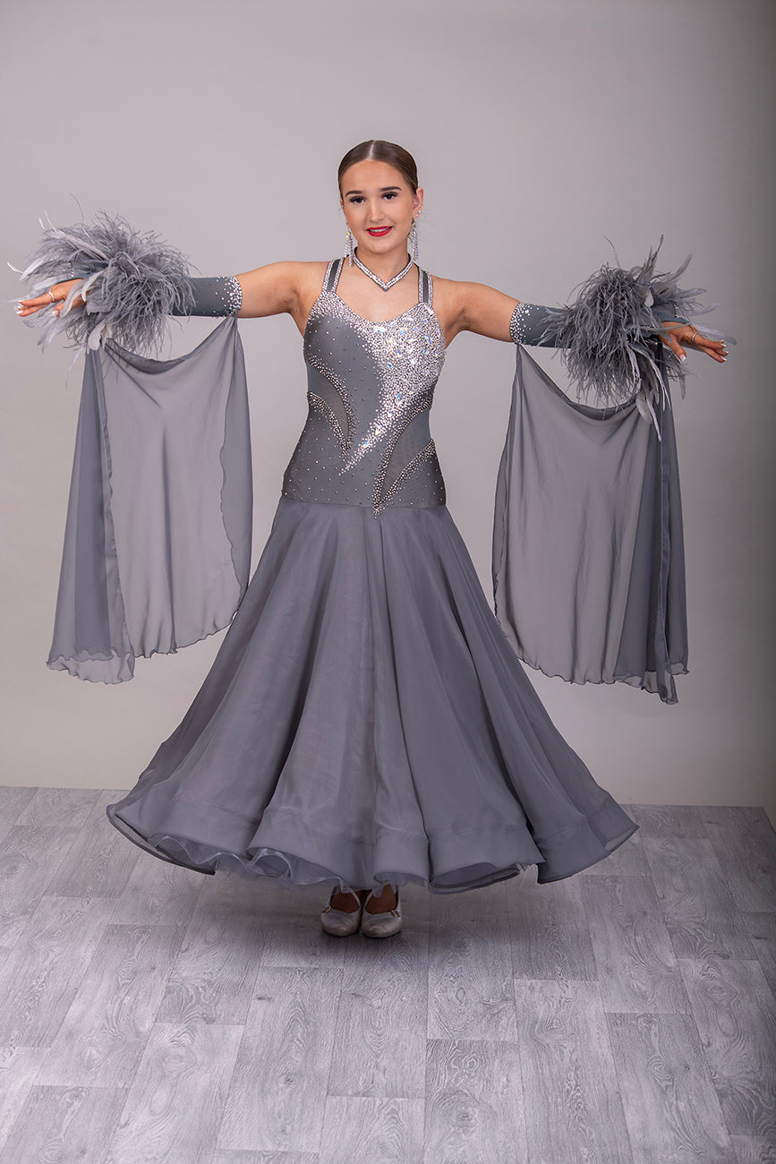 18B Hematite Ballroom/Sequence Competition Dance Dress. Heavily Stoned in AB, Moonlight & Jet Hematite. Detachable Floats & extra Feather Cuffs. Necklace with hanging details to the back.