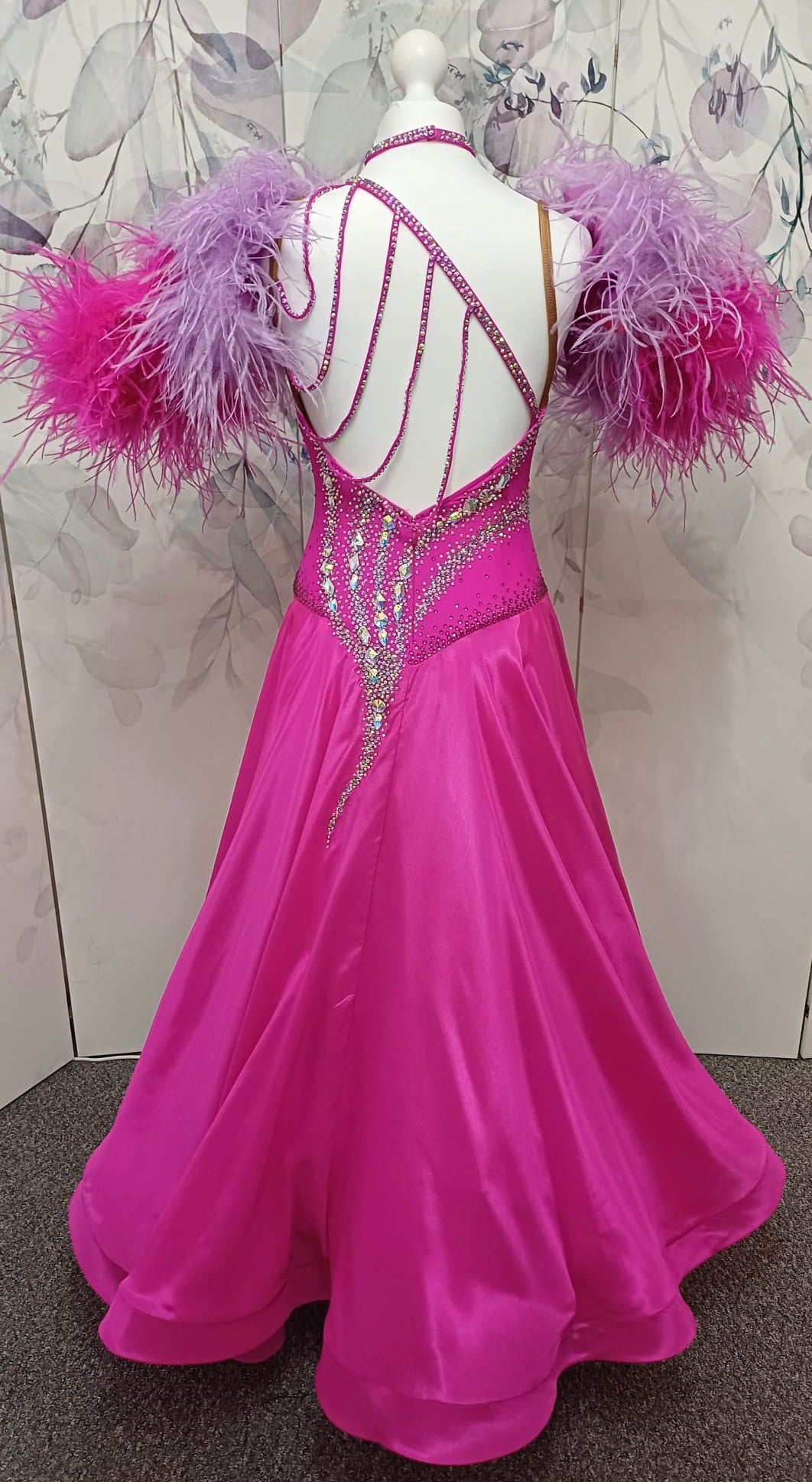 005 Cerise Pink Competition Ballroom Dance Dress. Heavily stoned in AB and Fuchsia & lilac. Comes with ostrich cuffs in Lilac & Cerise. Beautiful back detail.