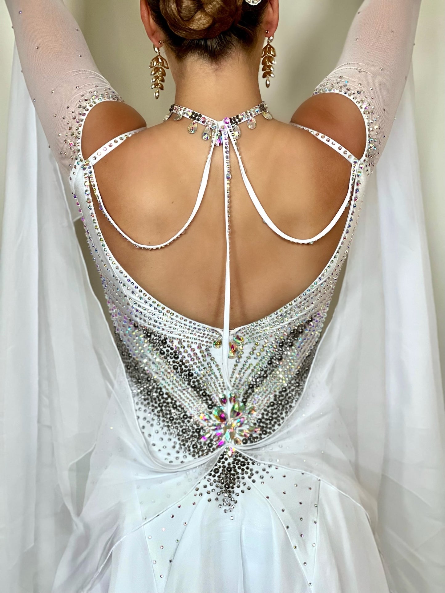 325 white Ballroom Dress decorated with Silver & AB stones. Strapping detail to the back & cold shoulder sleeves. Floats to the wrist.