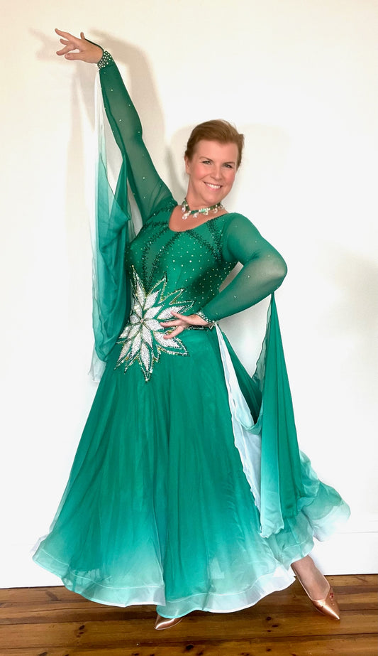 338 Emerald, Jade & White Ombré Ballroom Dress. Stunning decoration on waist in White decorated with gold & AB stones. Dress decorated with light & dark green stones. Ombré floats to back & sleeves.