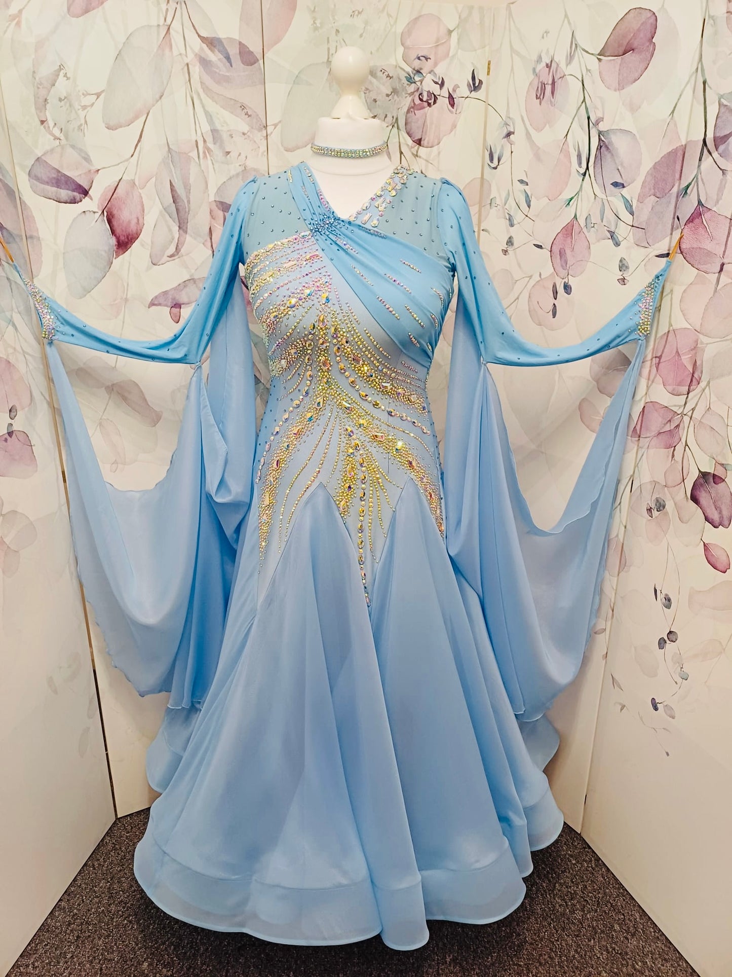 007 Light Blue Competition Ballroom Dance Dress. Heavily stoned in AB & Blue. Mesh overlay to one side of the bust continuing round to the back. Comes with detachable floats.