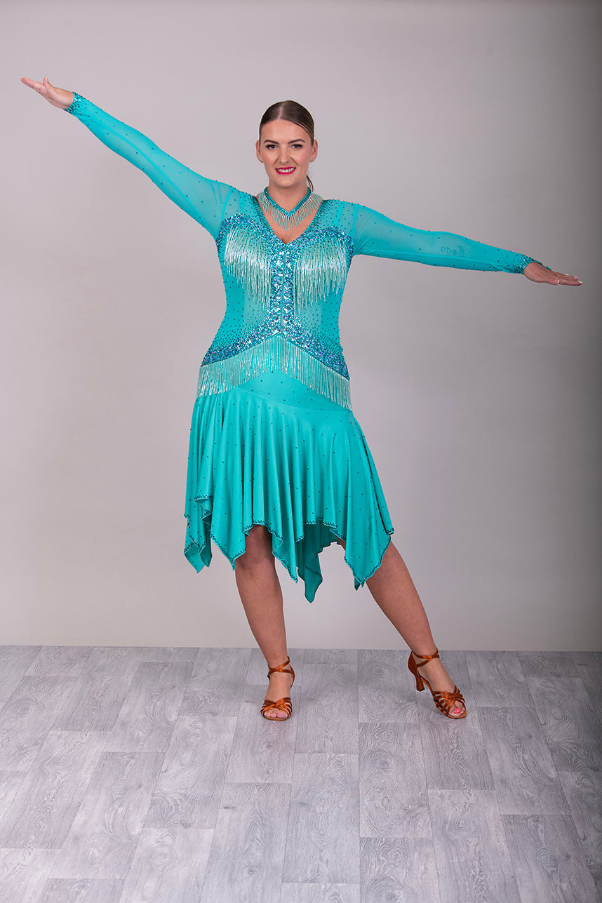 0101 Latin Dance Dress. Very full skirts giving maximum movement. Beading to the chest & waist area. Bodice back & front mesh with flesh under to allow the option to wear own Bra. Stunning stoning detail.