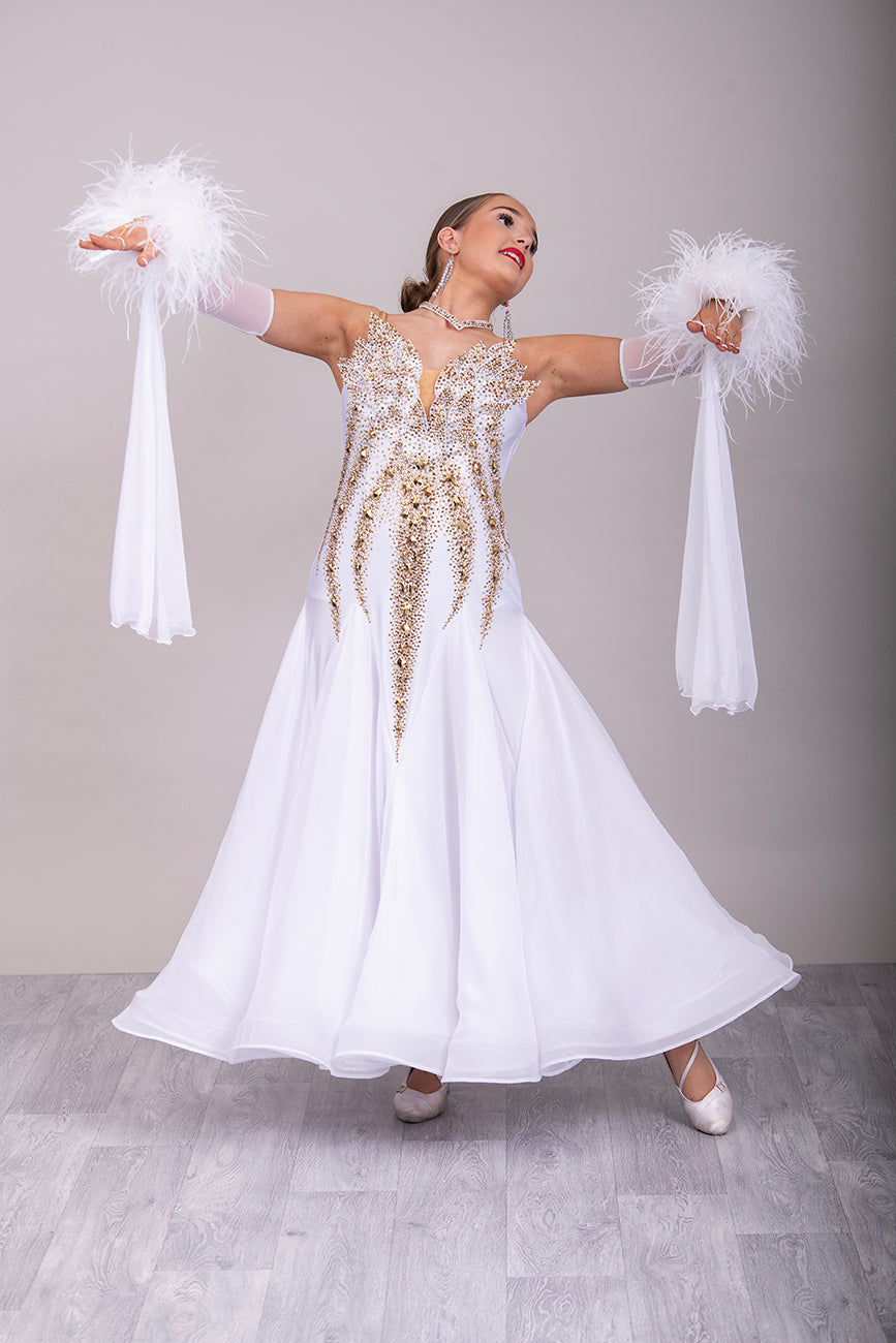 012 Stand out White & Gold Competition Ballroom Dance Dress. 3D design to the Bodice heavily stoned in Gold Ore & Golden Shadow. Detachable Floats with Ostrich feather cuffs.