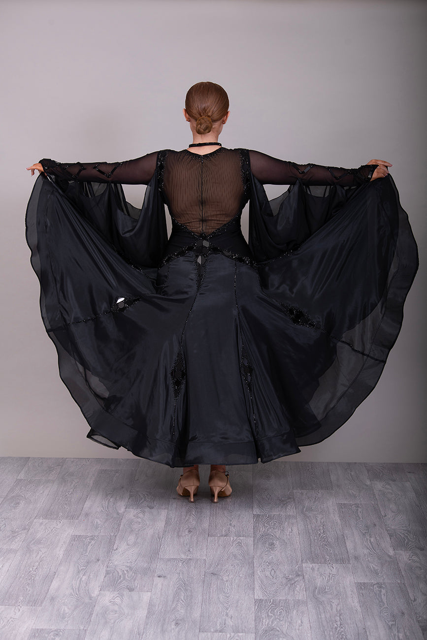 16B Black Ballroom/Sequence Competition Dance Dress. Heavily decorated in Black with Black Mirrors. Decoration continuing down into the Godet Points. A Stand Out & Sophisticated Dress