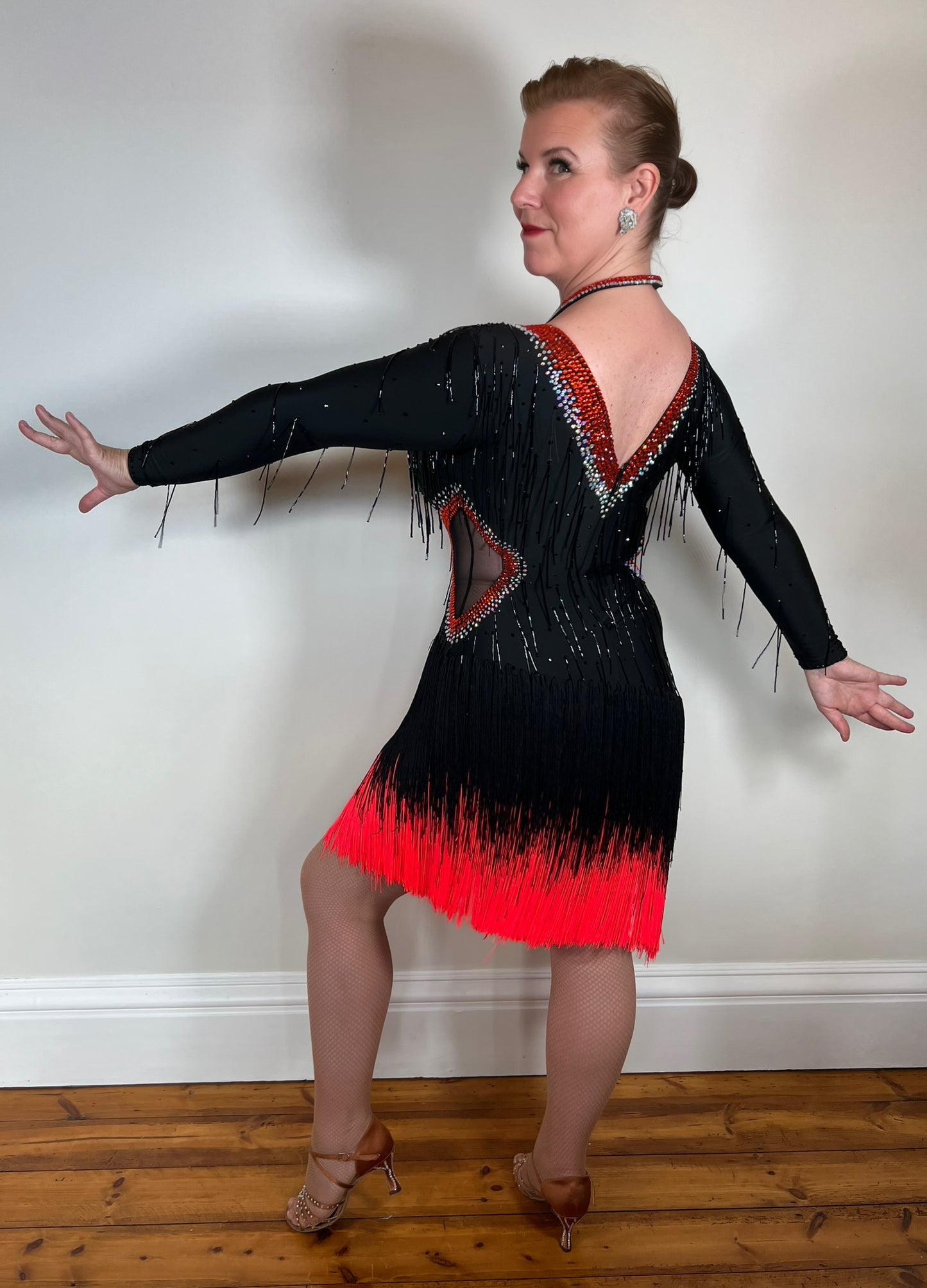 076 Black & Red Fringed Long Sleeved Competition Latin Dress. Black bed droppers to the body area with detailed neckline. Stones with light Siam & AB