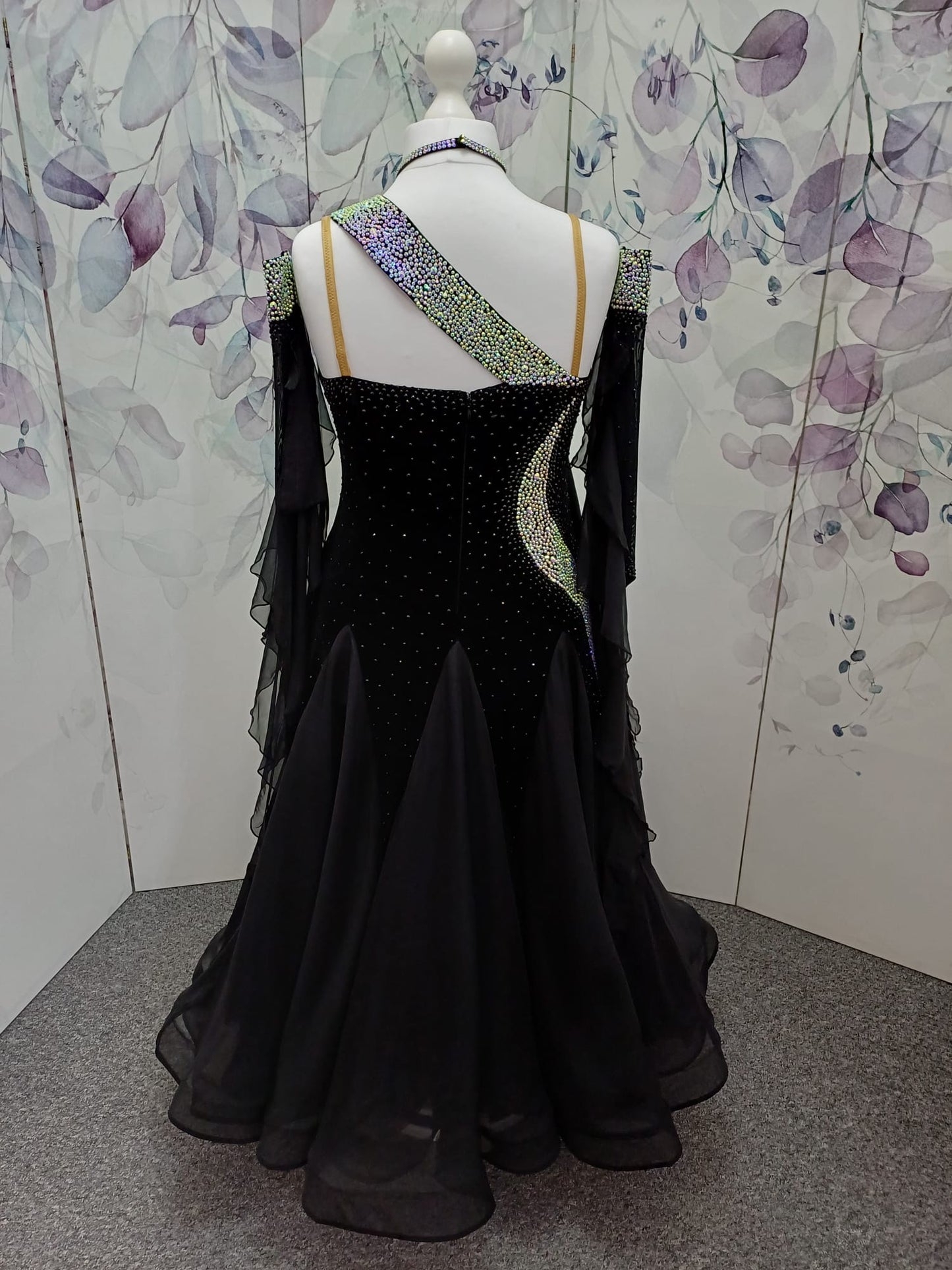 64B Classic Black Competition Ballroom dance dress. Flattering design heavily stoned in AB & Jet. Detachable floats. Satin frill to the front right bodice. Back high enough to wear own bra.