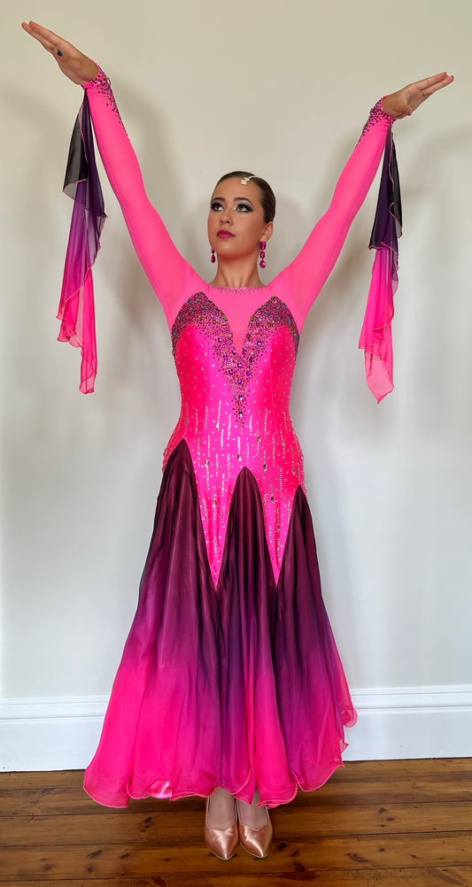 129 Electric Pink & Black Ombre Ballroom Dress. Decorated in Fuchsia & AB stones. Ombré floats from the wrist