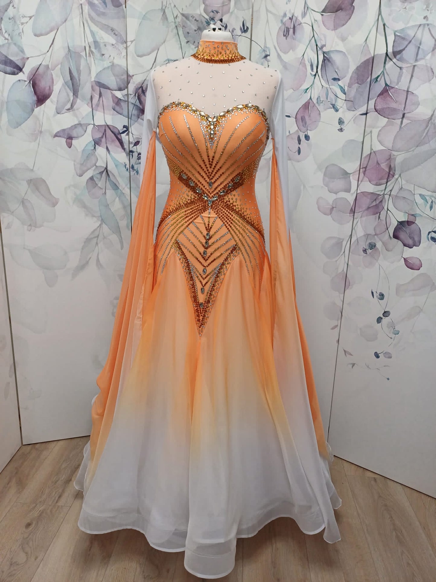 031 Pale Orange & White Ombré Ballroom Dress. Decorated in Smoked Topaz, Light Colorado topaz & crystal. High neck design with keyhole feature to the back. Ombré floats to the sleeves.