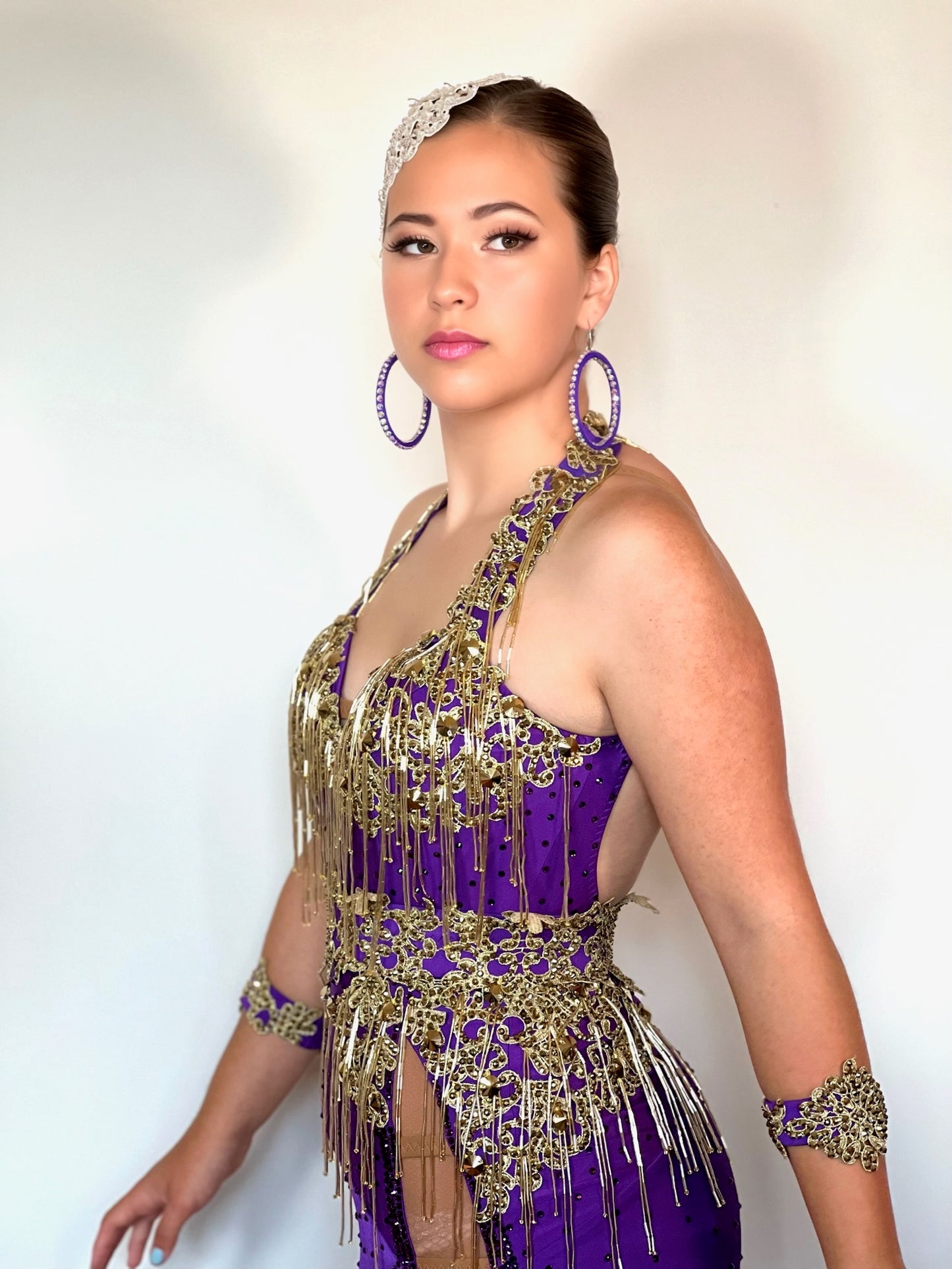 089 Purple & Gold heavily decorated Latin  Dress. Gold bead droppers, gold metallic appliqué & gold stones. Detachable belt with main dress stoned in purple velvet