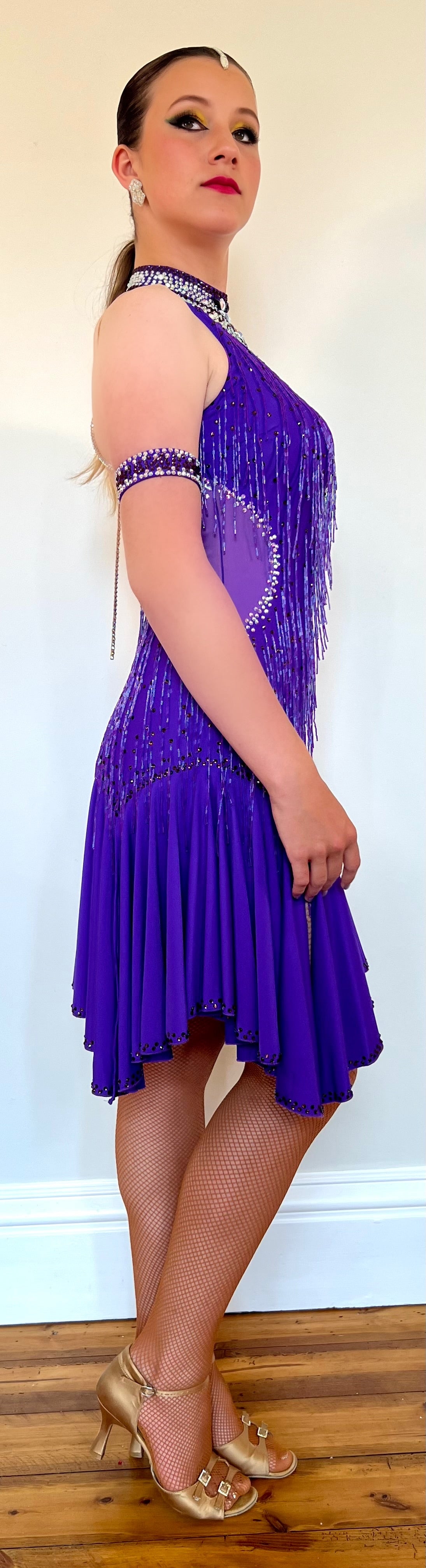 249 Purple High neck Latin dress. Detailed strapping to the back with high halter neck detail to the front. Full frill skirt giving maximum movement. Decorated in purple & AB stones