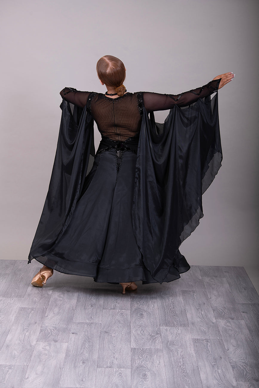 16B Black Ballroom/Sequence Competition Dance Dress. Heavily decorated in Black with Black Mirrors. Decoration continuing down into the Godet Points. A Stand Out & Sophisticated Dress