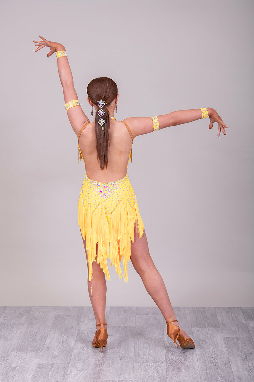 260 Yellow Fringe detailed skirt Latin Dress. AB stones with golden droppers to the chest. Open detailing to the front.