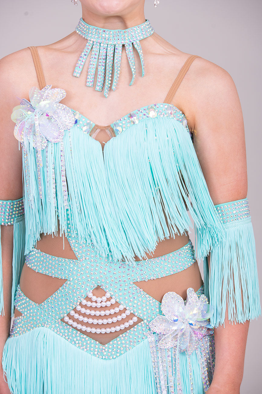 (BUDGET)8 Icey Blue Latin Competition Dance Dress. stoned AB & pearls. Flower to chest & hip, fringe skirts.                                           *****Our New Budget Range are Bought in ready made Costumes, with some detail added by TWDance*****