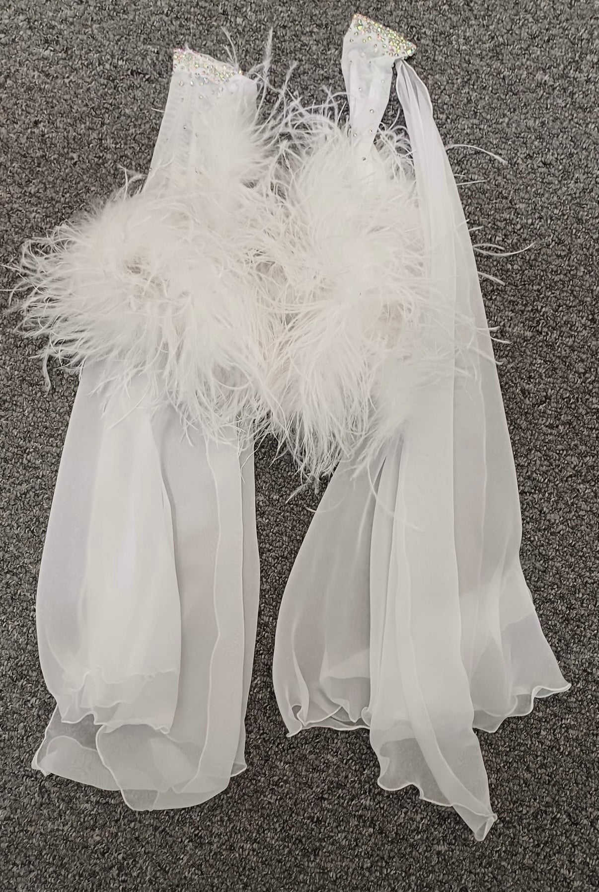 013 White Competition Ballroom/Sequence Dance Dress. Striking detailing to both the front & Back. Stoned in AB and sunshine. Cones with gloves, floats & Ostrich Boa cuffs.