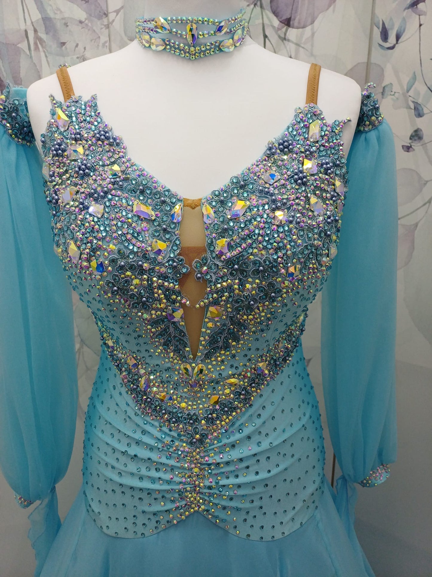 72B TWD Petite Beautiful Blue Competition Ballroom/Sequence Dance Dress. Heavy appliqué stoning to upper chest in Light Sapphire & AB. Separate puff arms with detachable wrist floats. ❤️Showroom Appointments Available❤️