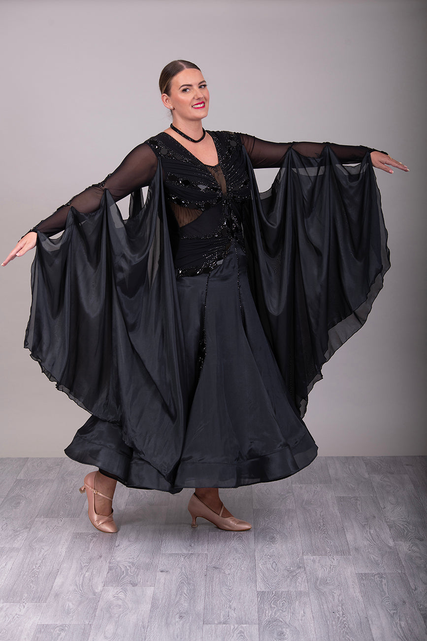 16B Black Ballroom/Sequence Competition Dance Dress. Heavily decorated in Black with Black Mirrors. Decoration continuing down into the Godet Points. A Stand Out & Sophisticated Dress