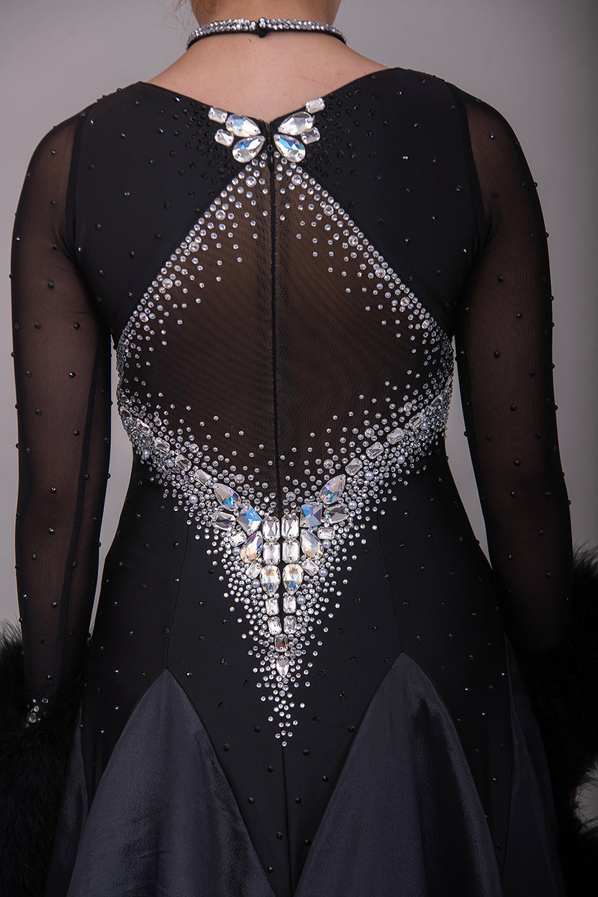 324 Black Ballroom Dress with feather floats to the wrist. Rouched detail to the chest area. Heavily decorated stoning to the front & back in AB. High back.