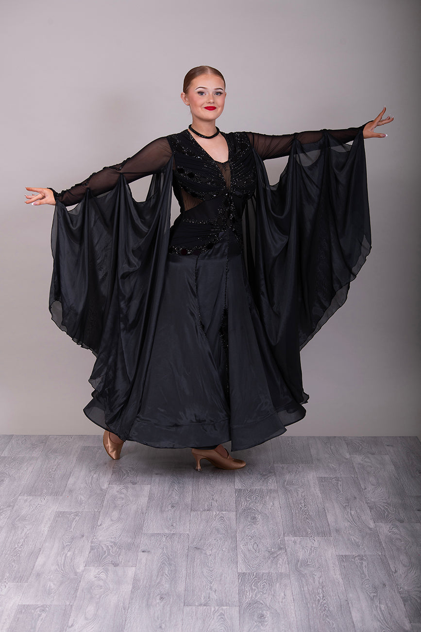 16B Black Ballroom/Sequence Competition Dance Dress. Heavily decorated in Black with Black Mirrors. Decoration continuing down into the Godet Points. A Stand Out & Sophisticated Dress