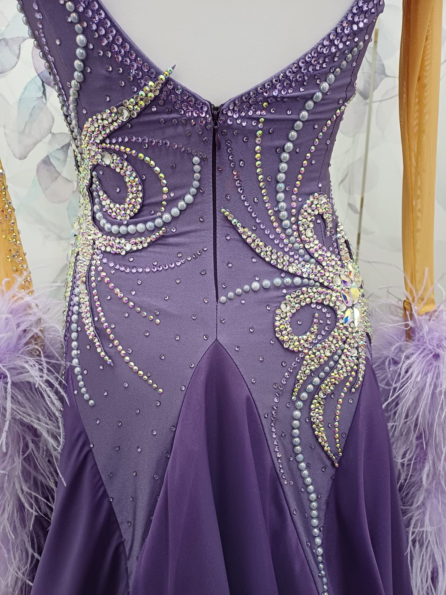 63B Deep Violet Competition Ballroom/Sequence Competition Dance Dress. Heavily stoned in AB, Amethyst & Violet. Motif decoration to upper left shoulder & hip. Feather Boa floats & flesh Gloves. ❤️Showroom Appointments Available❤️