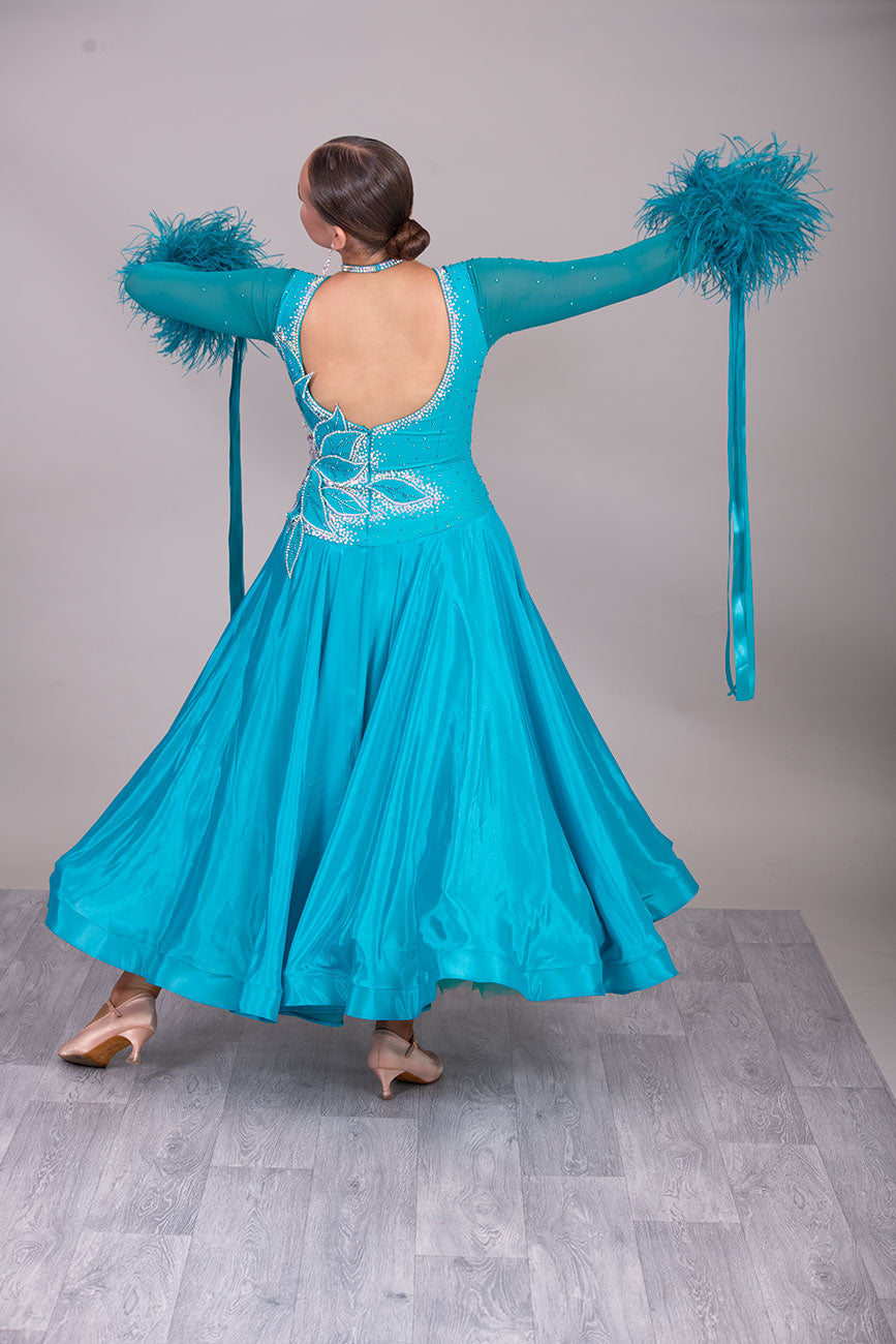 26B “TWD ELITE” Teal competition Ballroom/Sequence Dance dress. New Fuller skirts/Underskirts with 3D design to front and back. Stoned in AB & Blue Zircon. Detachable Ostrich Feather Floats