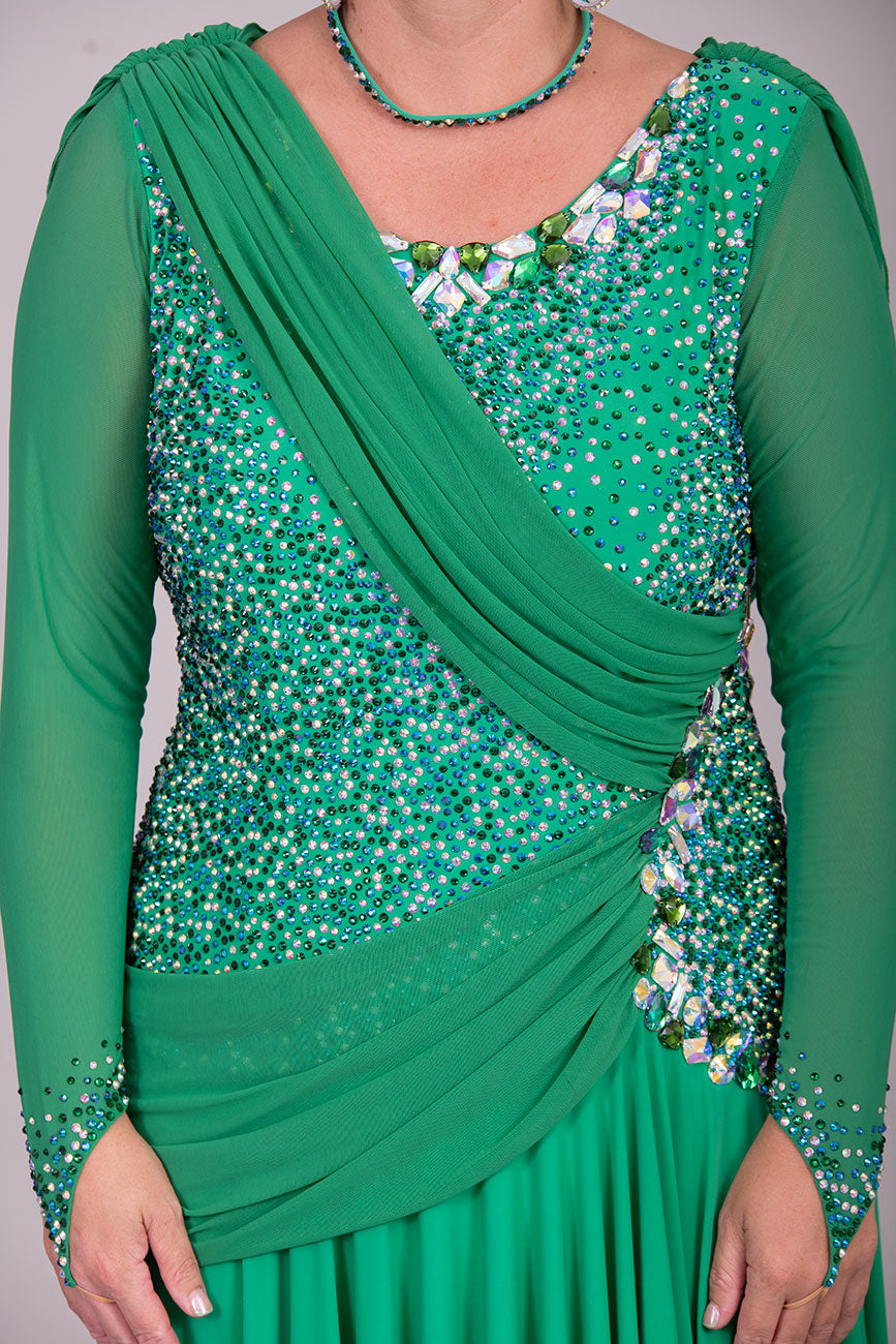 115L Emerald Green Competition Latin Dance Dress. Stunning dense stoning in AB, Emerald & Emerald AB. Sash details to the chest & Hip. High Back to give option of wearing own bra