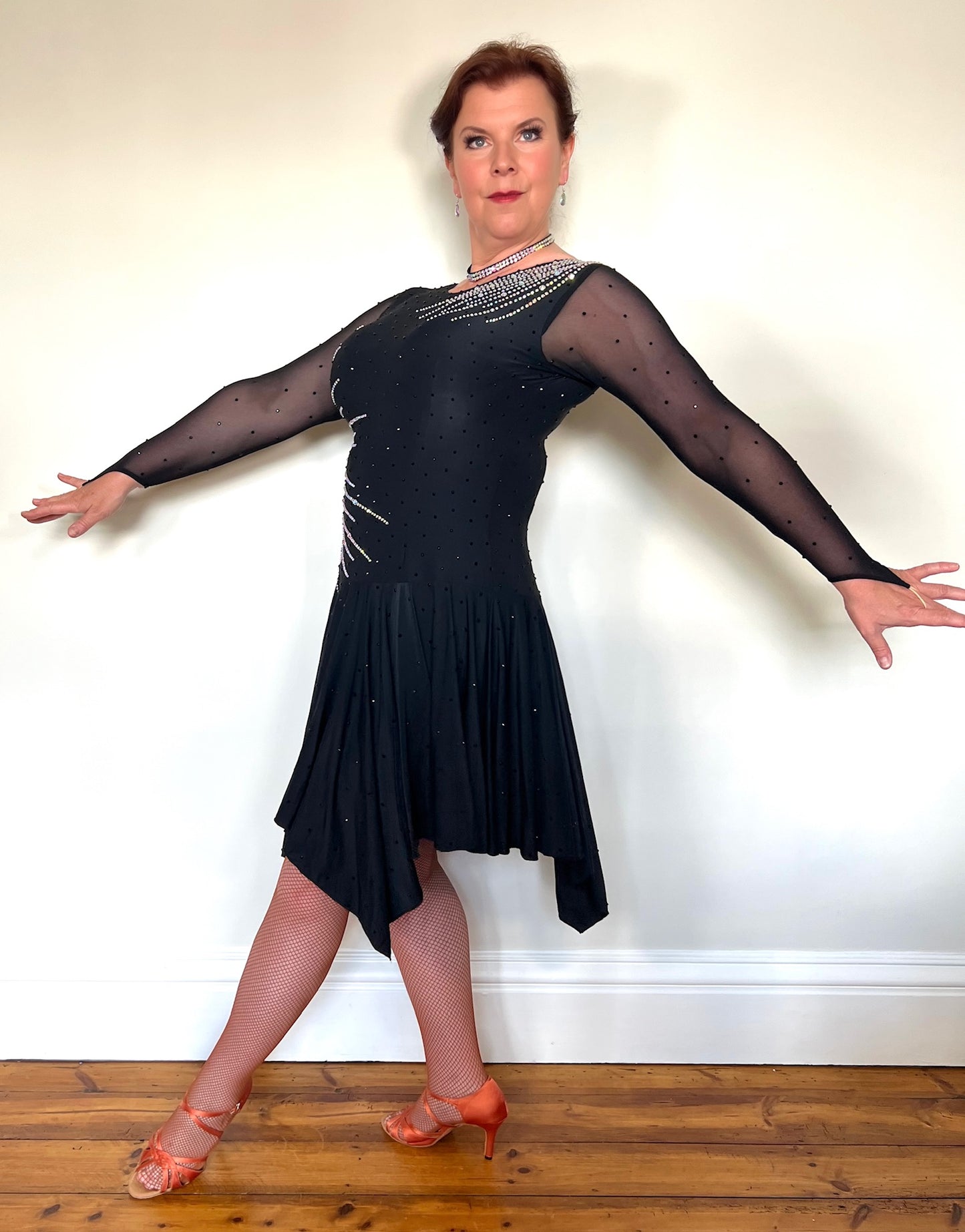 199 Flattering Black Latin Dance Dress. Super Stretchy. Stoned in AB starburst design with handkerchief hem skirt. High back giving option for wearing own bra.